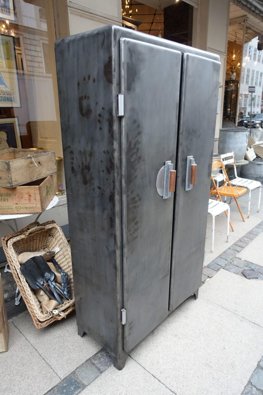 Gorgeous vintage French iron kitchen cupboard, with rounded edges and two tall doors. Behind the doors, there are practical drawers, bottle holders, and hooks (used to hang meats and garlic for example). Treated and polished to reveal its true