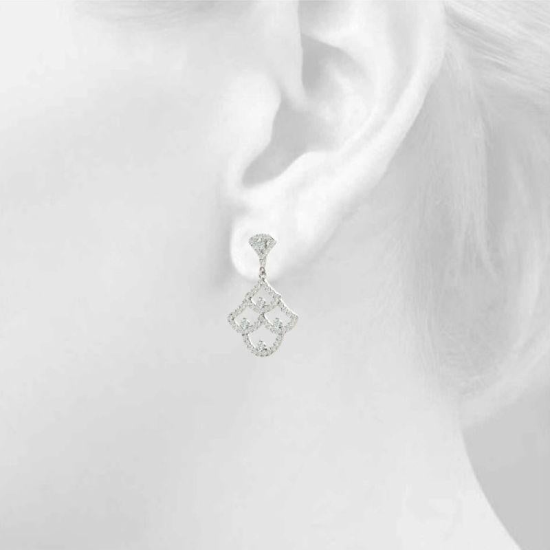 Handcrafted in New York, these Art Deco-inspired chandelier earrings in 14K white gold showcase approximately 0.96 carats of round brilliant diamonds. Designed with graceful openwork and vintage-era charm, each diamond is meticulously hand-set and