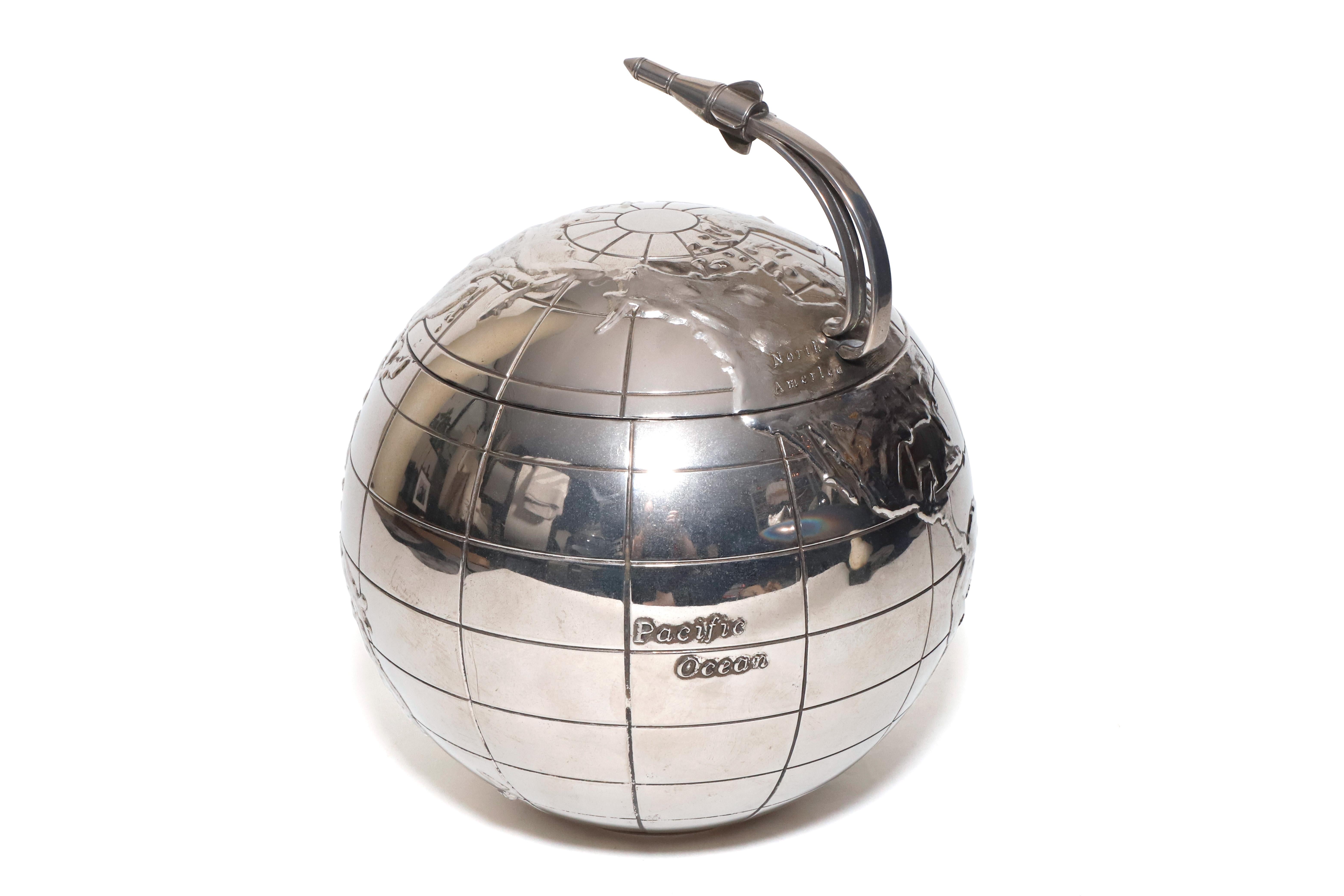 International Silver Co. Globe ice bucket with rocket ship handle made in the 1960s. Silver plated unique piece perfect for a bar setting with a removable platic insert for easy use and cleaning. International Silver label on bottom. 

Property