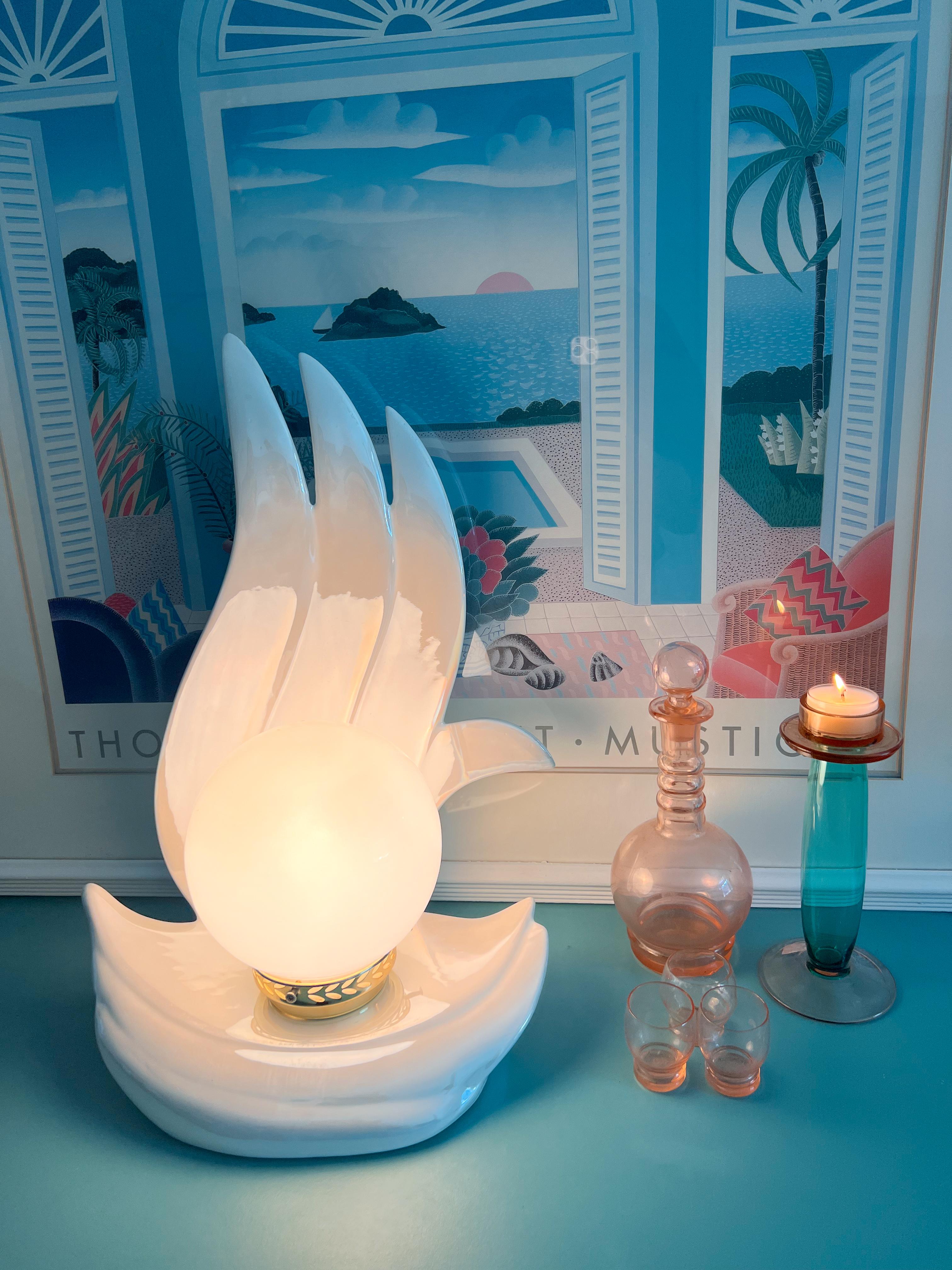 Stunning Art Deco sculptural table lamp with a flame design. The lamp have a white ceramic glaze with an iridescent finish. The lamp is in amazing condition, free from any chips, cracks, or scratches.
Wired in EU plug.