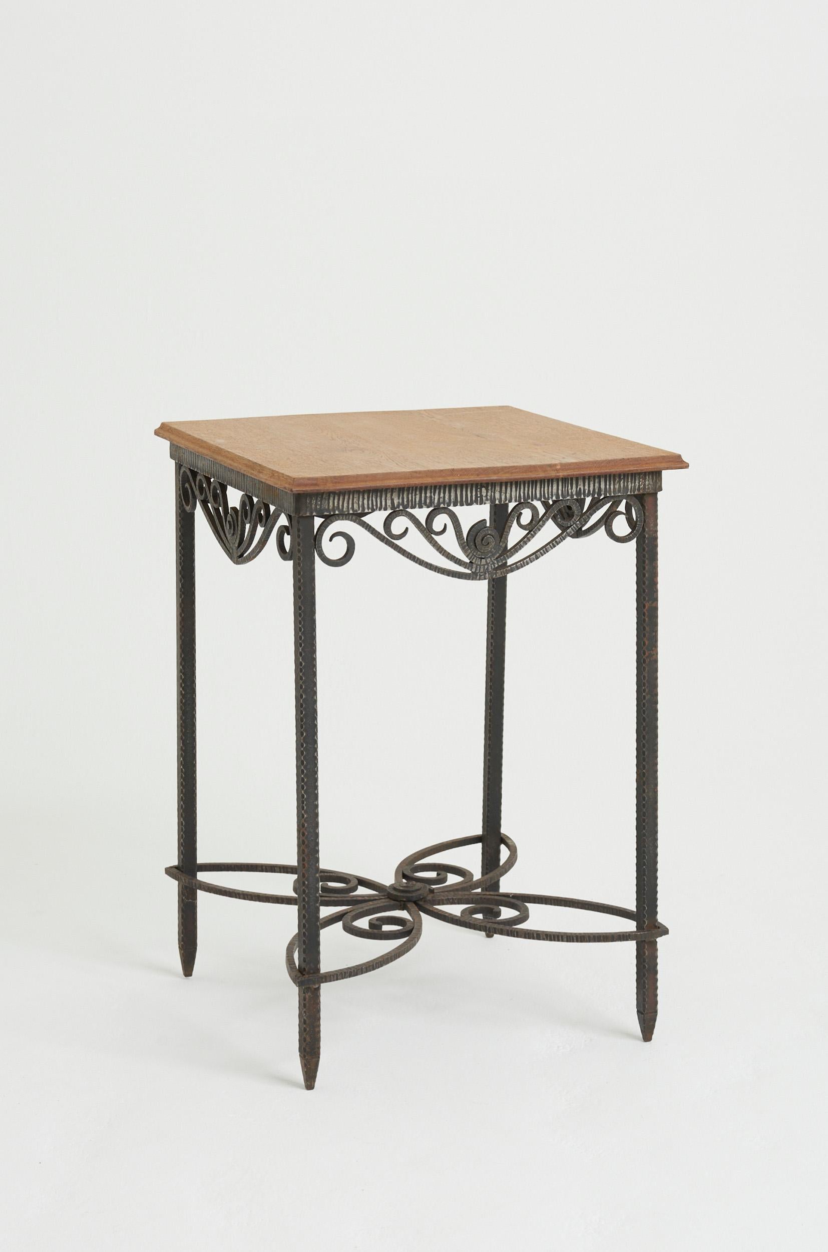 An Art Deco wrought iron and oak top table.
France, Circa 1920
75 cm high by 54 cm wide by 54 cm depth