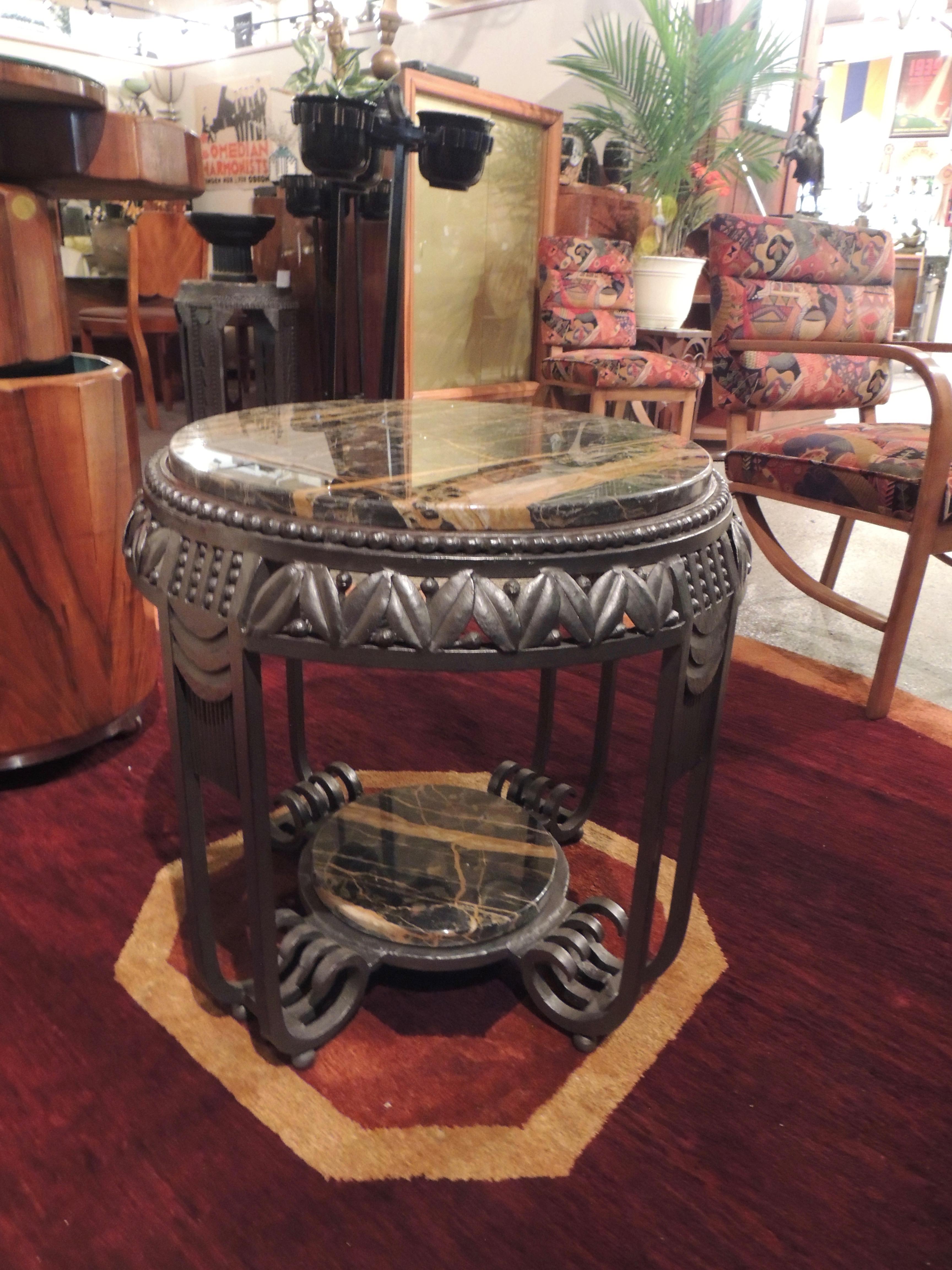 Spectacular Art Deco iron table, custom-made for Art Deco collection in the original “Fer Forge” French tradition with a top made of richly veined Portoro marble. The ironwork is a faithful rendition of the style made popular by Edgar Brandt, with