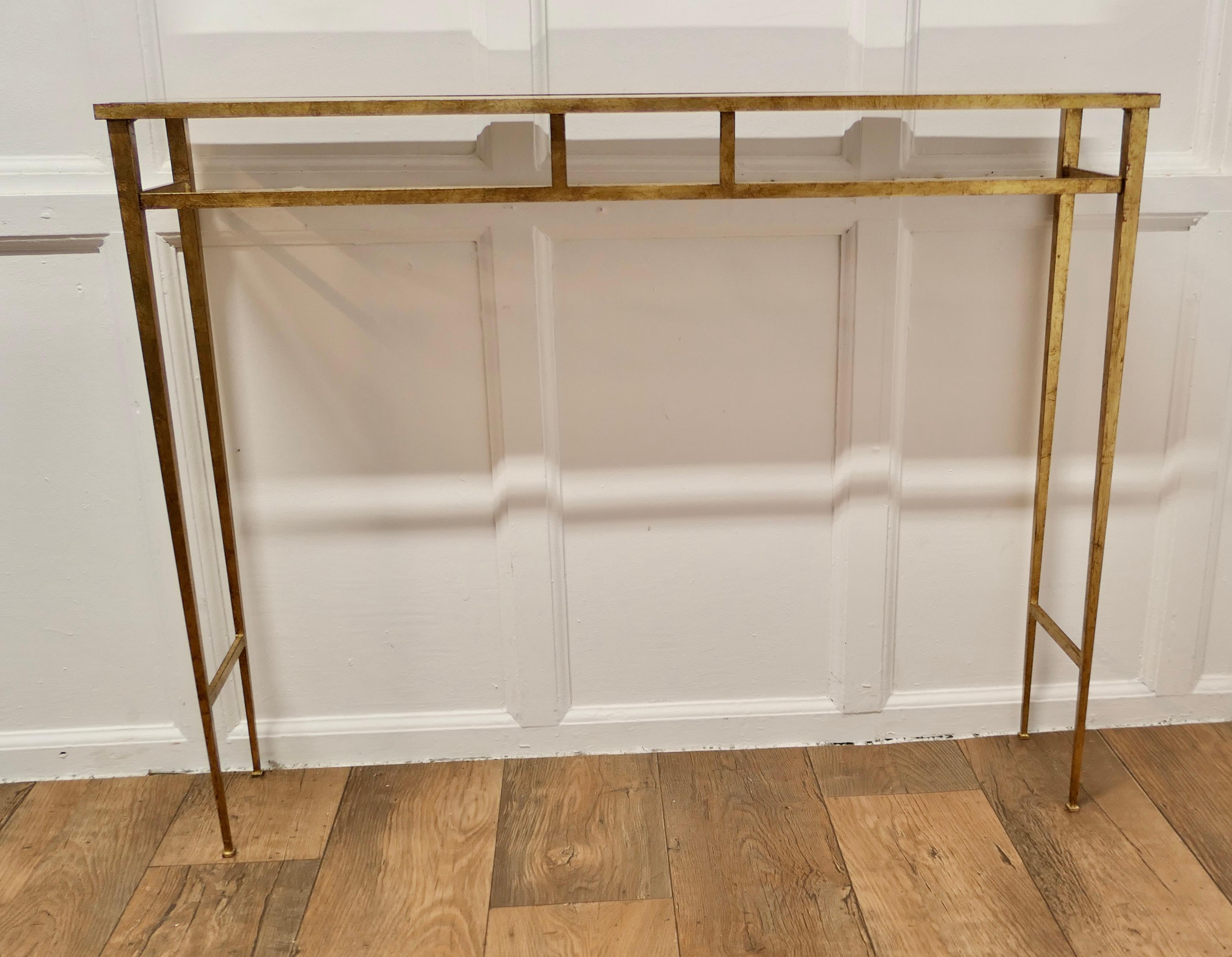 Art Deco Italian Brass Console or Hall Table 

This is a very stylish piece it has brass tubular square legs and a mirrored top, the table is in good sound condition and the mirror top has quite a bit of foxing giving it a very stylish look

The