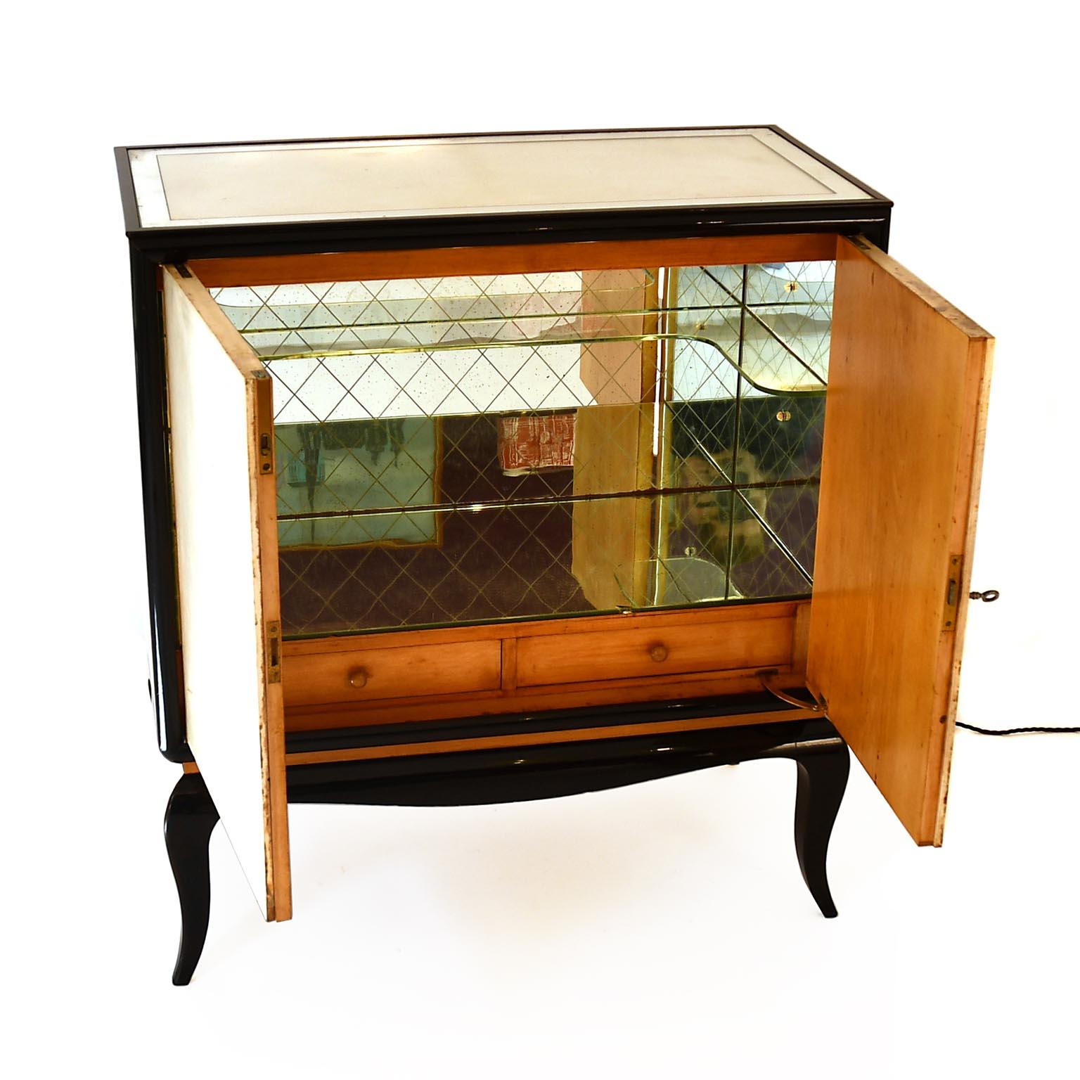 Art Deco glass bar cabinet in the style of Osvaldo Borsani. 
Hardwood legs dyed to rosewood. All glass parts are in original condition. The first 3 centimetres of the edge of the glass top are mirrored. The glass plates inside are mirrored and have