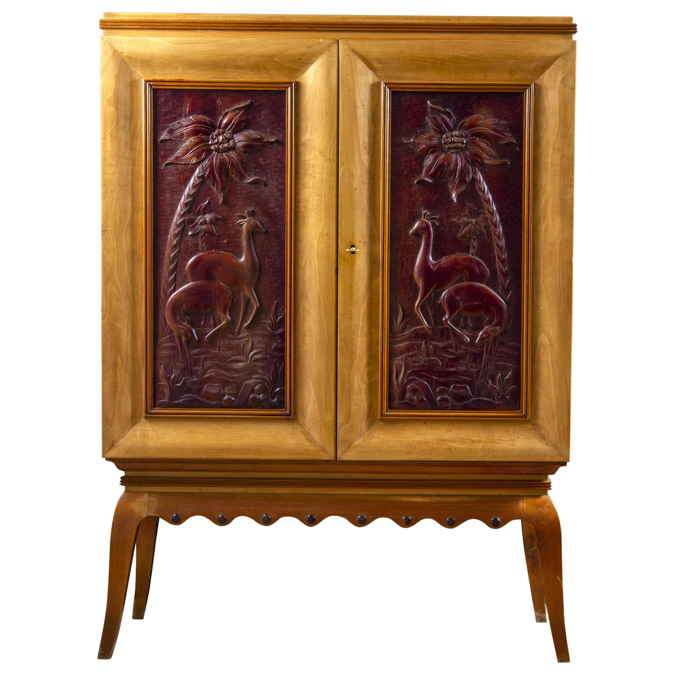 Elegant and unusual bar cabinet.
Decorated front door with finely carved bas-reliefs deer panel door that opens to a mosaic mirror lined interior with one glass shelf and three pull-out drawers. Door panels inside with mosaic mirror and elegant