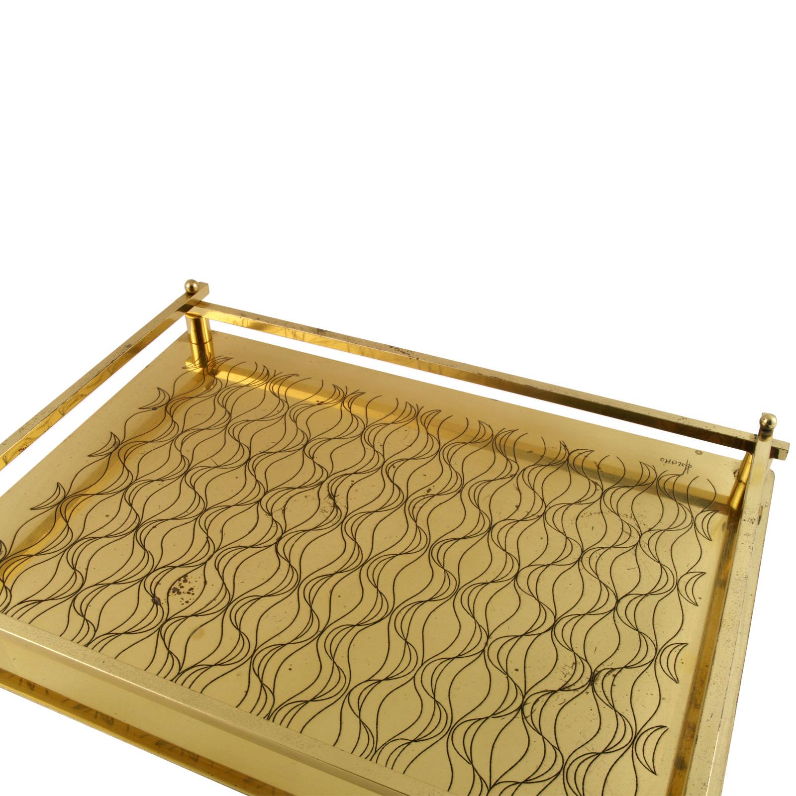 Art Deco age Italian tray table in golden metal decorated with geometric shapes
The tray has some small gilding stain.