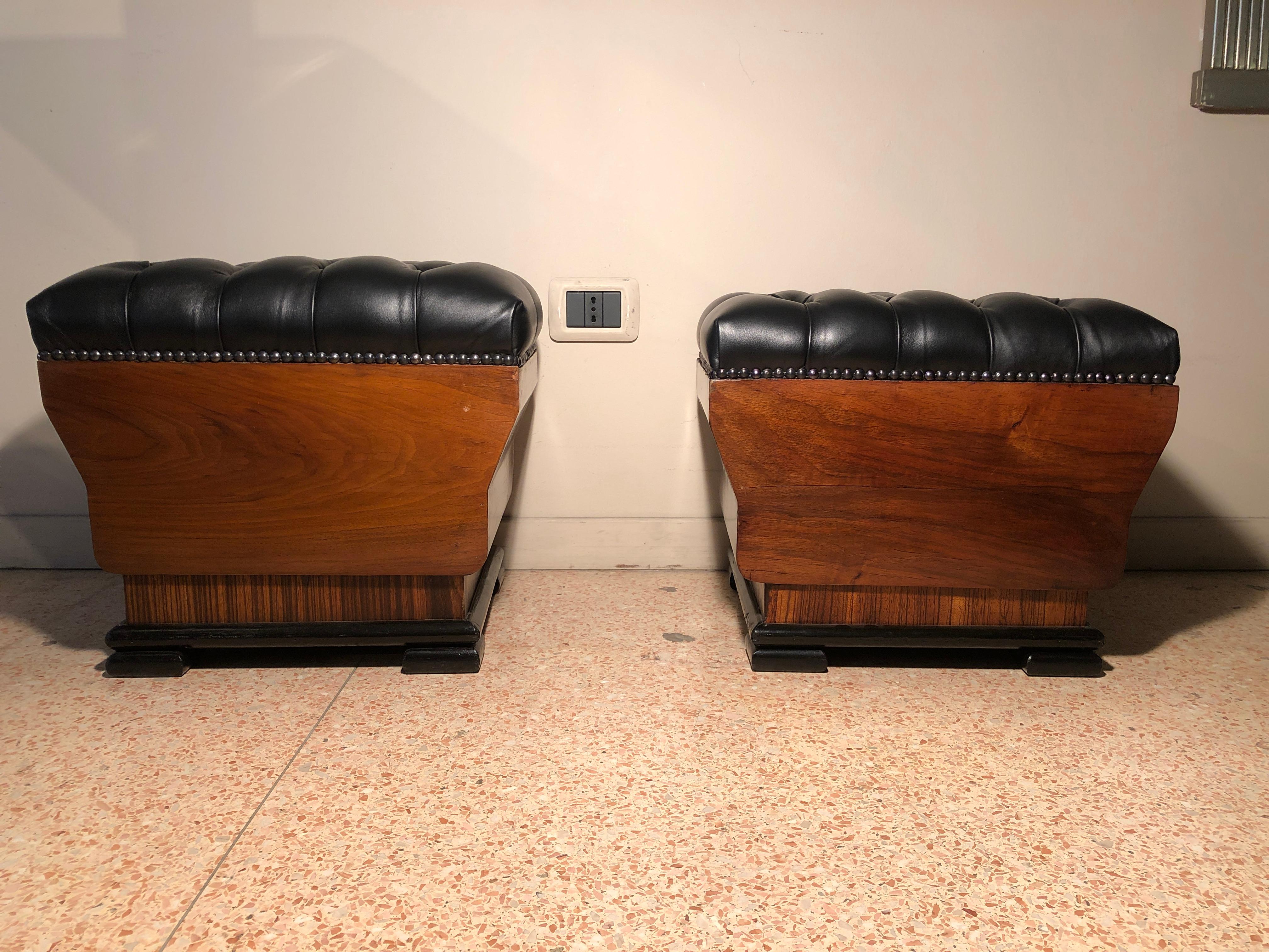 Pair of small and versatile poufs. They have been reupholstered with premium quality black leather. The wood parts have been restored and re polished by hand with wax finishing. They are slightly different in sizes. The bigger is H 37 , W 42 , D 34