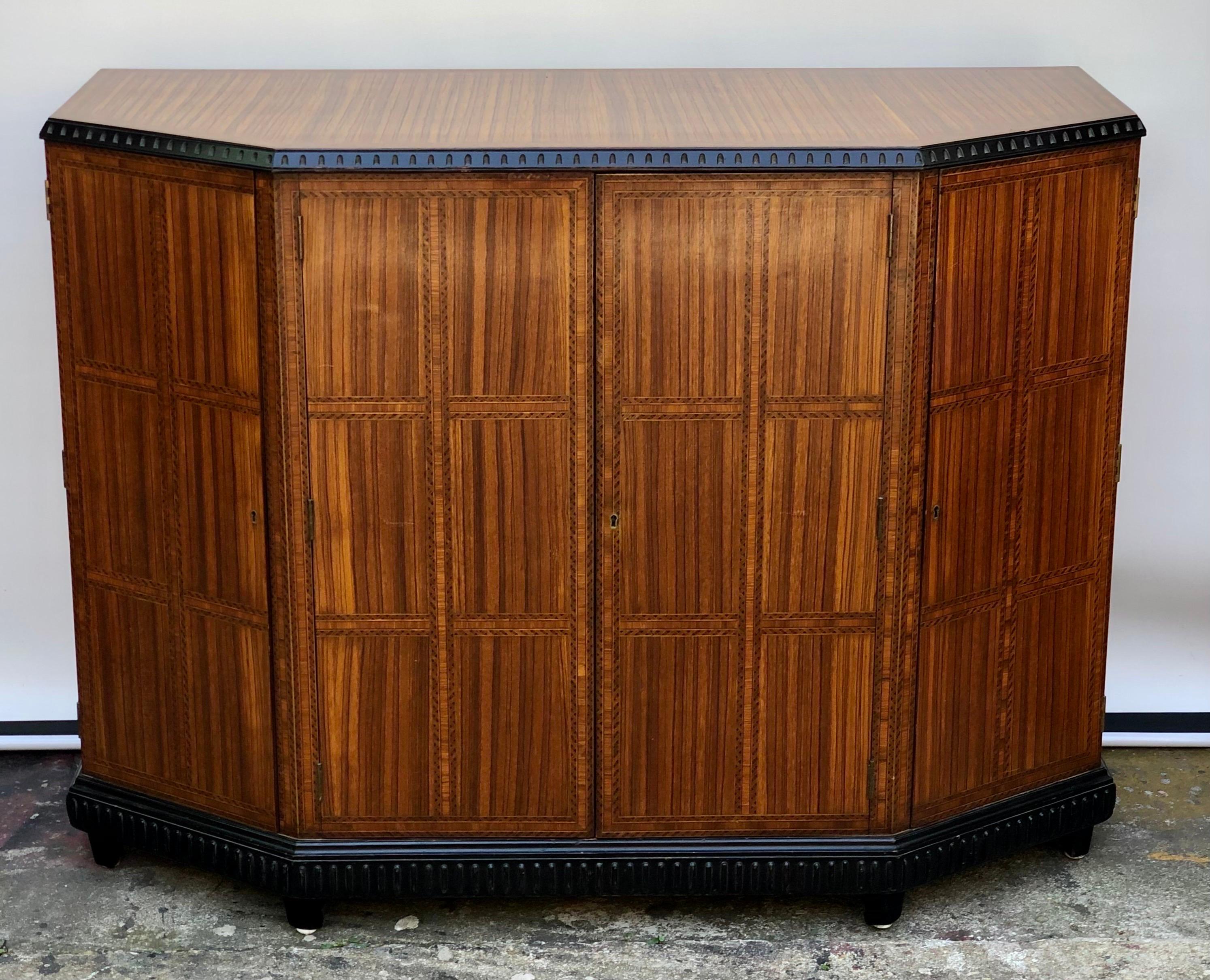 Exotic Art Deco Italian Zebra wood inlaid credenza was made in Italy in the early 20th century. This stunning Deco Credenza is a true work of art displaying exotic wood veneers of zebra wood, satinwood, and ebony. The beautiful inlay is framed