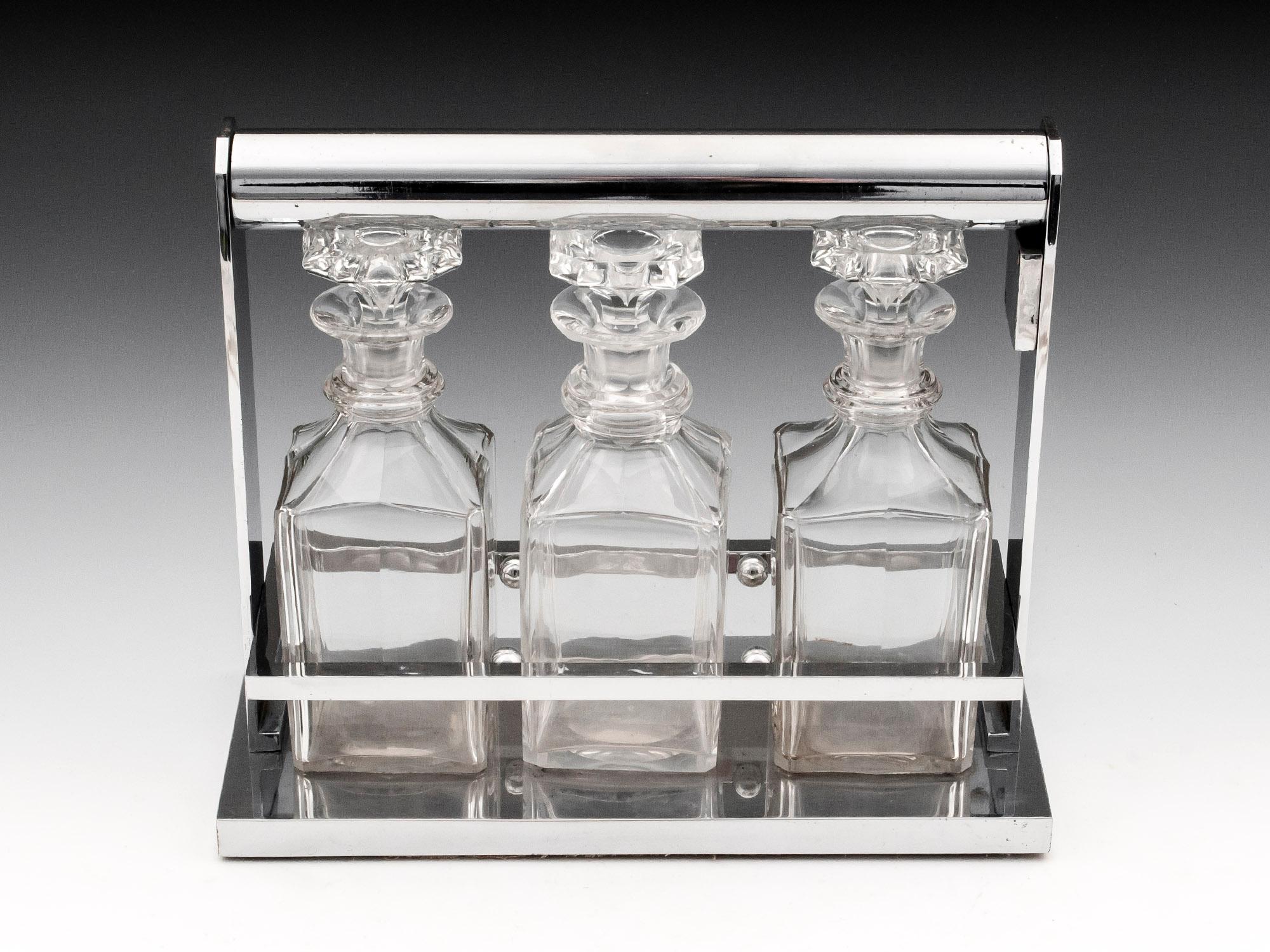Chromium Plated 

From our Tantalus collection, we are pleased to offer this Jacques Adnet Tantalus. The Tantalus of regular form with a Chromium plated body featuring three crystal glass decanters with stoppers. When unlocked the carry handle