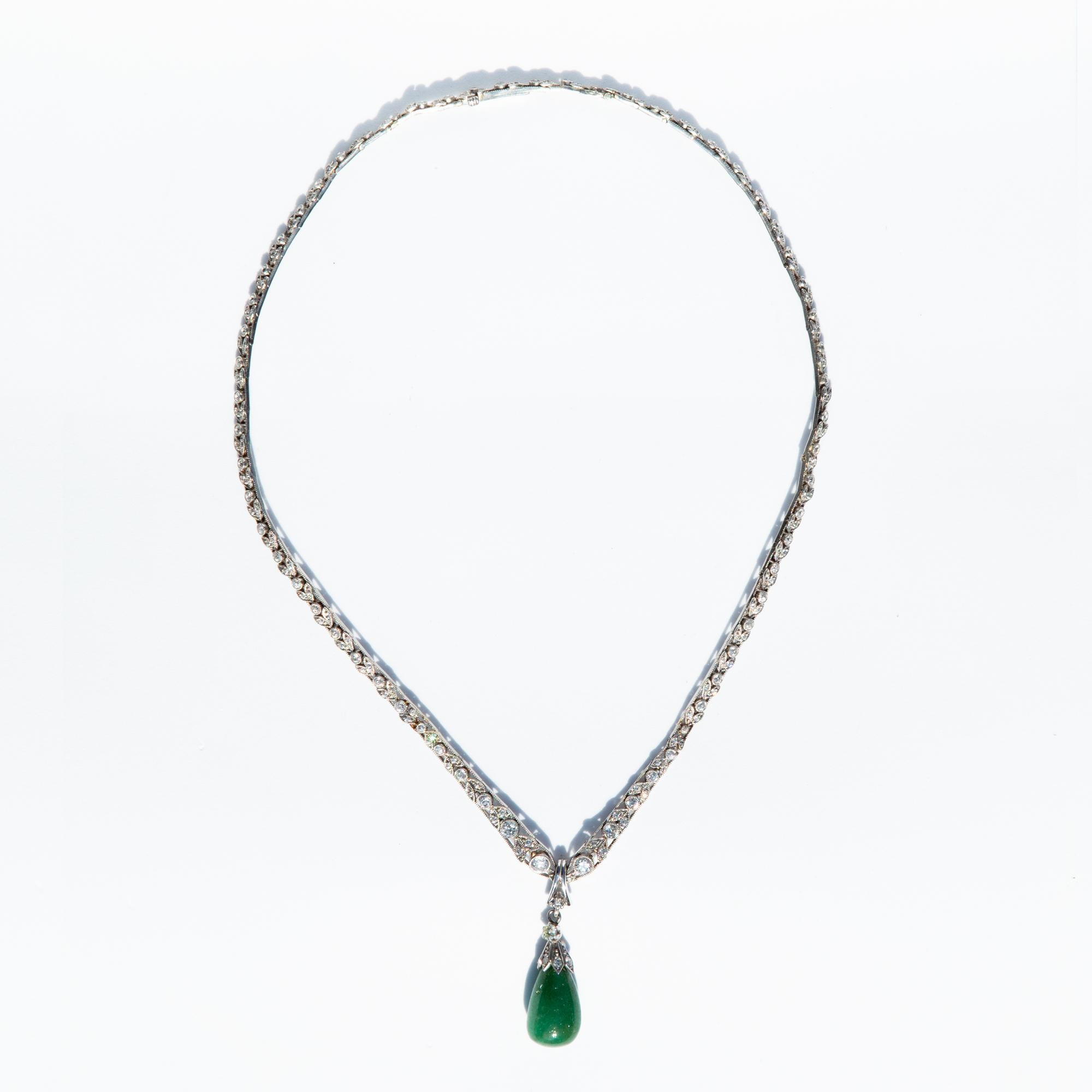 A stunning Art Deco graduated diamond necklace, set in platinum with a beautiful jade baroque pendant. Cradled in a diamond bale setting. 

 