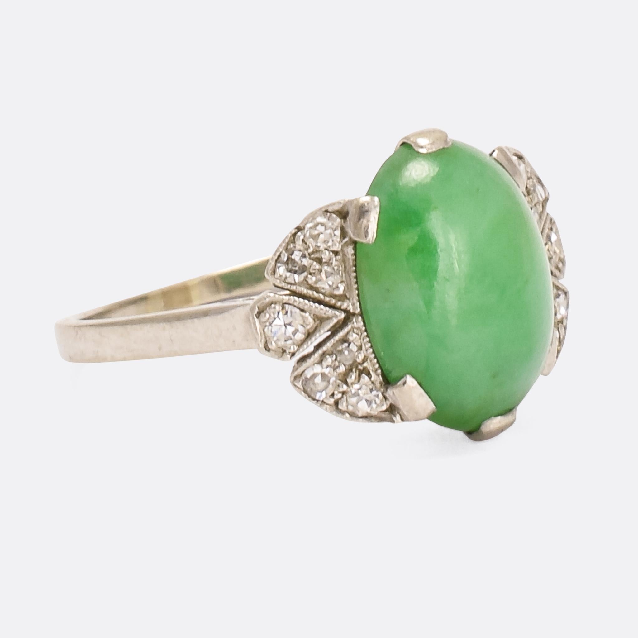 A stunning Art Deco period cocktail ring home to an exceptional jade cabochon. The principal stone rests in a six-claw setting and displays excellent colour; it’s accented by 14 eight cut diamonds, which rest in millegrain platinum settings, seven