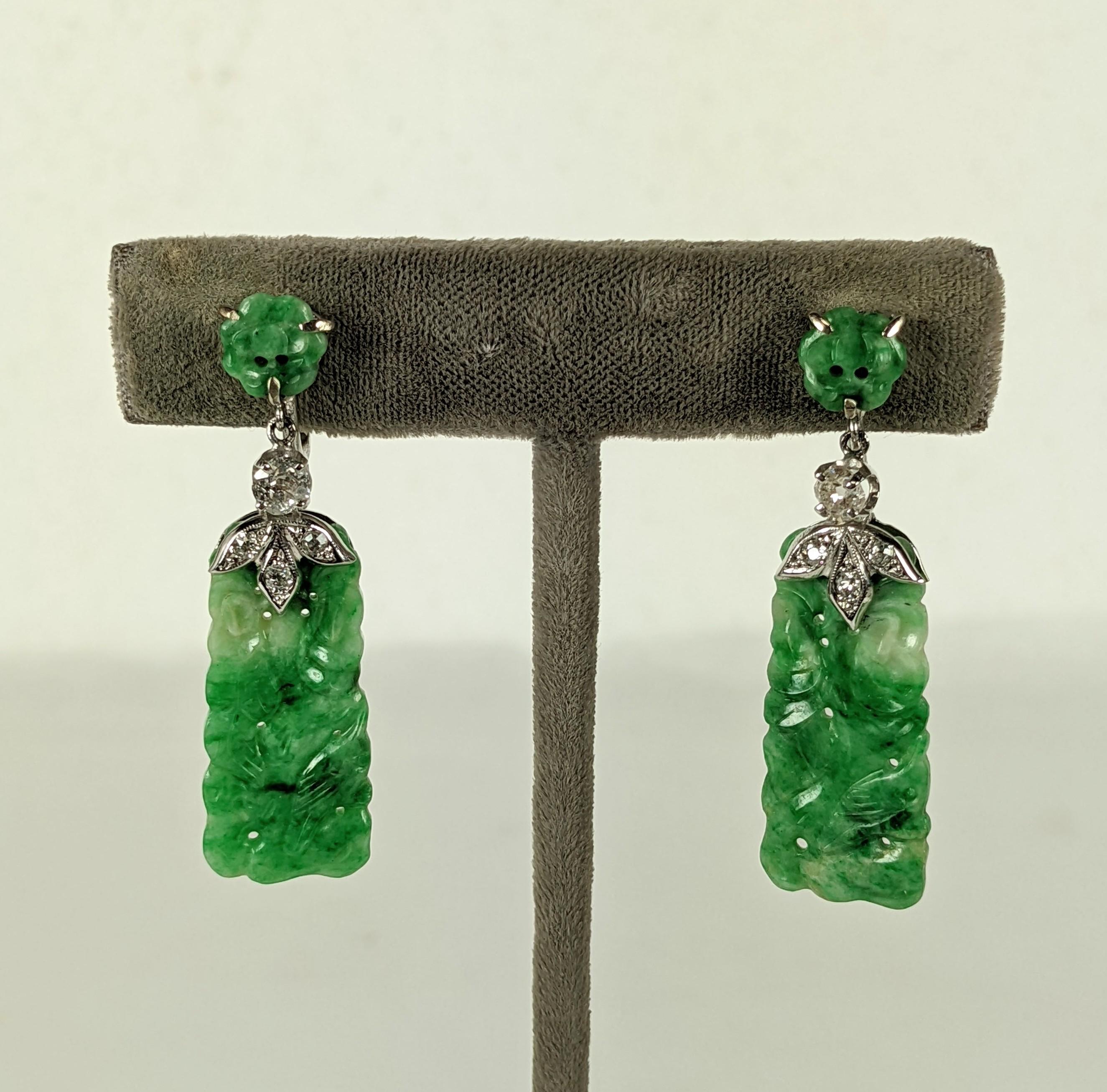 Art Deco Jade Diamond Earrings from the 1930's set in 14k white gold. Carved antique jade panels are held by a diamond floriform top with antique cut diamond (approx. 20 points) connectors. Jade carved flower at ear with screw back fittings.
1930's