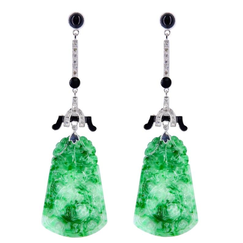Aston Estate Jewelry Presents:

A pair of Art Deco style jade and onyx earrings in platinum. Featuring rich green jade drops carved with detailed lotus flowers in a traditional Chinese manner. Pave set throughout with single cut diamonds of 0.30ctw