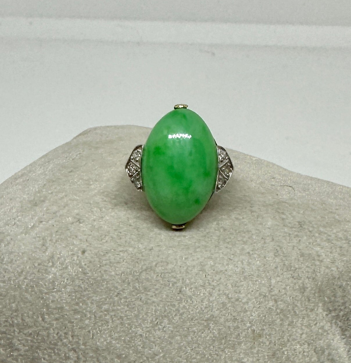 This is a stunning antique Art Deco Jade, Diamond and Platinum atop 14 Karat Yellow Gold Ring.  The Wedding Ring, Engagement Ring or Cocktail Ring with a superb natural oval Jade Cabochon of great beauty is accented by 6 sparkling White Diamonds set