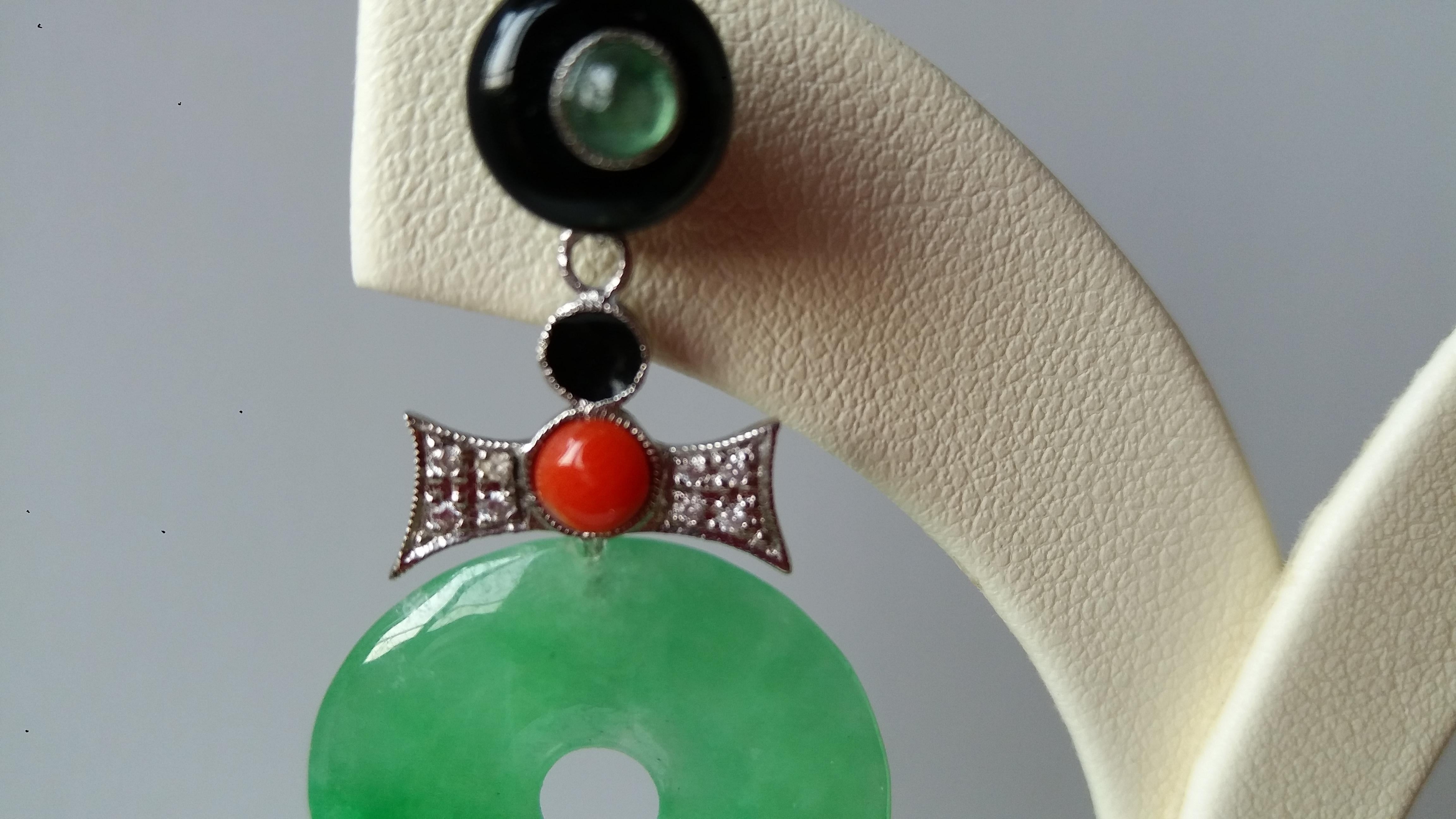 Round black onix buttons tops with small round emeralds cabochons in the center,middle parts in white gold, 16 round full cut diamonds, coral, black enamel, 2 Burma Jade Donuts
Length 40 mm
Width 21 mm
Weight 9 grams
In 1978 our workshop started in