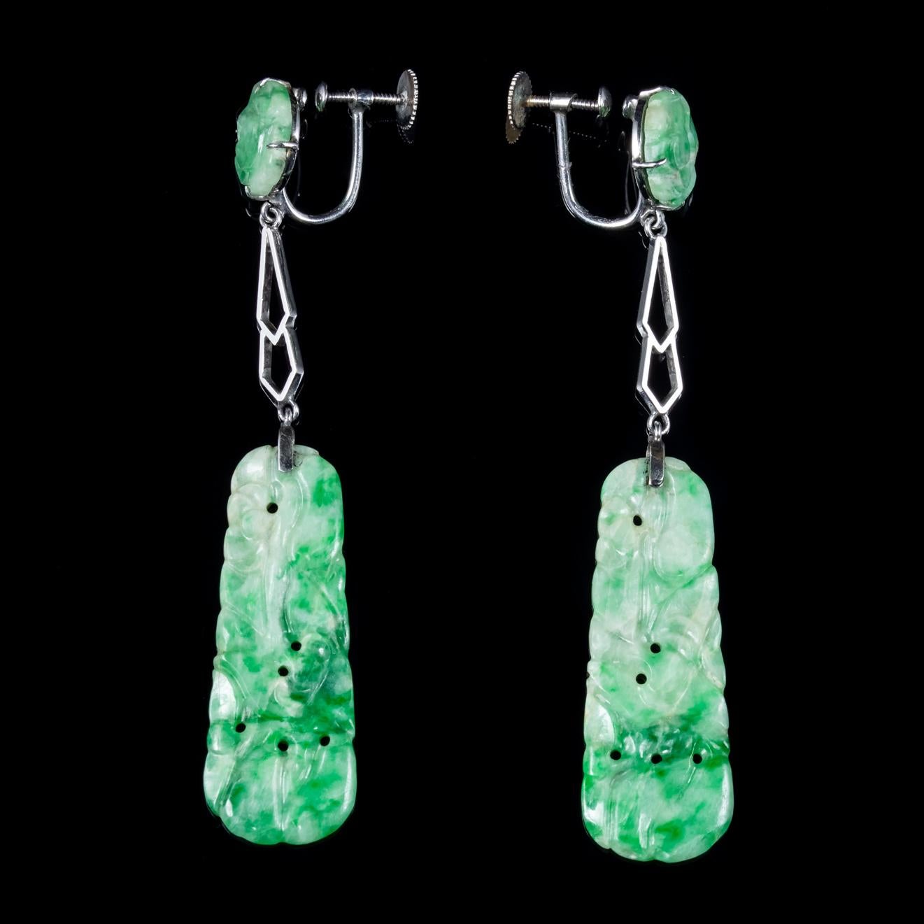 A spectacular pair of Art Deco drop earrings featuring beautiful carved Jade stones the largest of which dangles from a long gallery and displays beautiful engraved patterning. 

Jade is considered the ultimate ‘Dream Stone’ and has been admired in