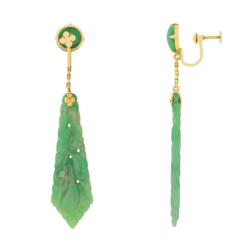 These fabulous art deco earrings feature beautifully carved jade. The jade is a lovely soft green and has high lustre. The bottom portion of the jade is intricately hand carved. The setting is made of 18 carat rose gold, which contrasts nicely to