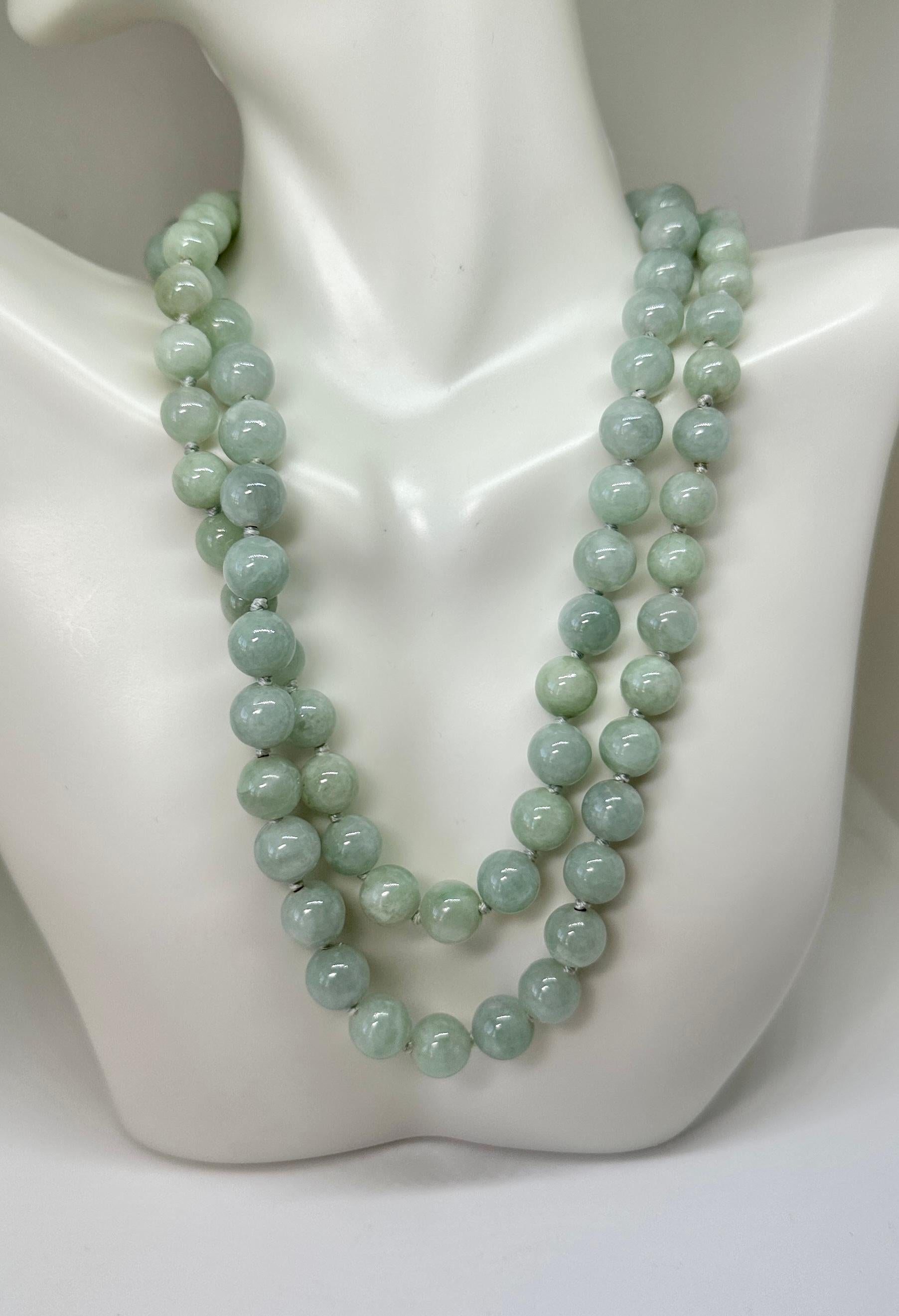 THIS IS AN EXQUISITE ART DECO JADE AND 14 KARAT YELLOW GOLD BEAD NECKLACE OF 30 INCHES IN LENGTH.  THE STUNNING NECKLACE HAS GORGEOUS 10MM JADE BEADS WITH A WONDERFUL 14 KARAT YELLOW GOLD FLOWER MOTIF CLASP.  EACH BEAD IS INDIVIDUALLY KNOTTED.  THE