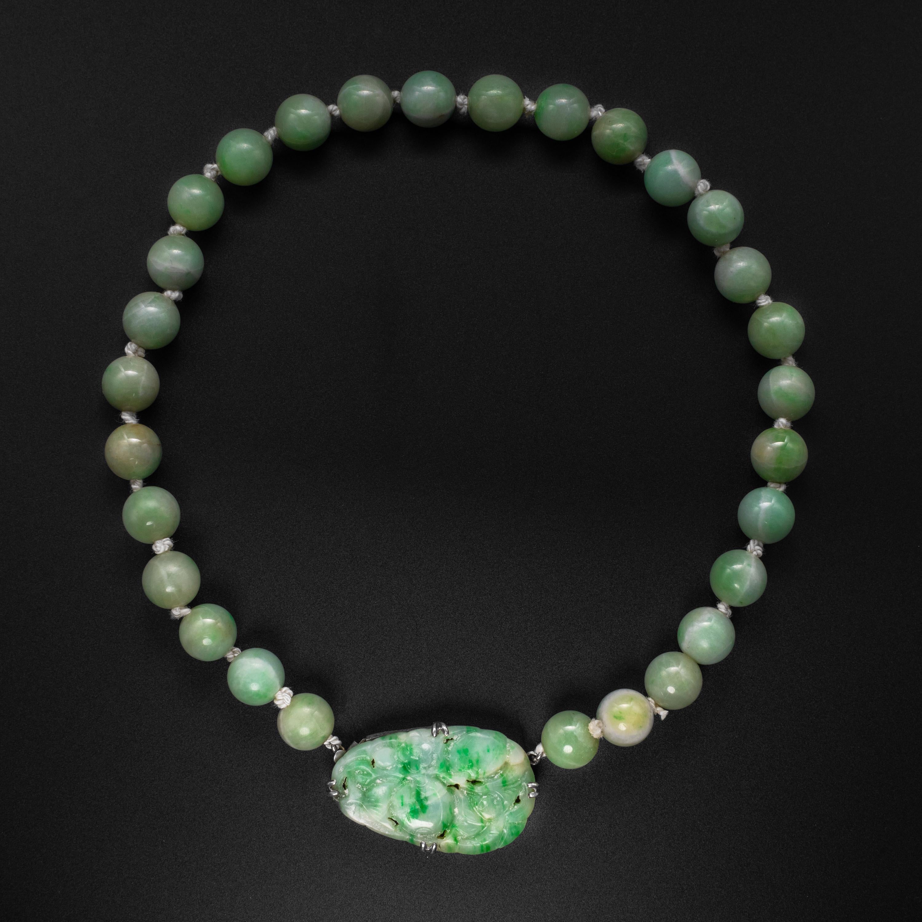 This Art Deco jadeite jade necklace features 29 11mm tender, young green Burmese jadeite beads, each of which was hand-carved and polished without the use of electricity or modern polishing aids. Jade beads of this size are uncommon. They have the