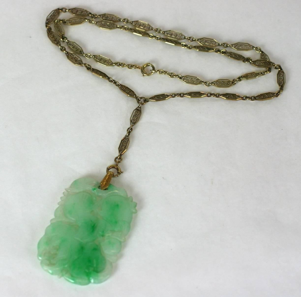 Art Deco Jade Pendant on ornate wirework lorgnette chain. Natural jade is hand carved and pierced with fruit and leaf motifs. Intricate 14k Art Deco wirework link chain ends in an engraved bale suspending the jade pendant. 1920's USA. Jade, Chinese