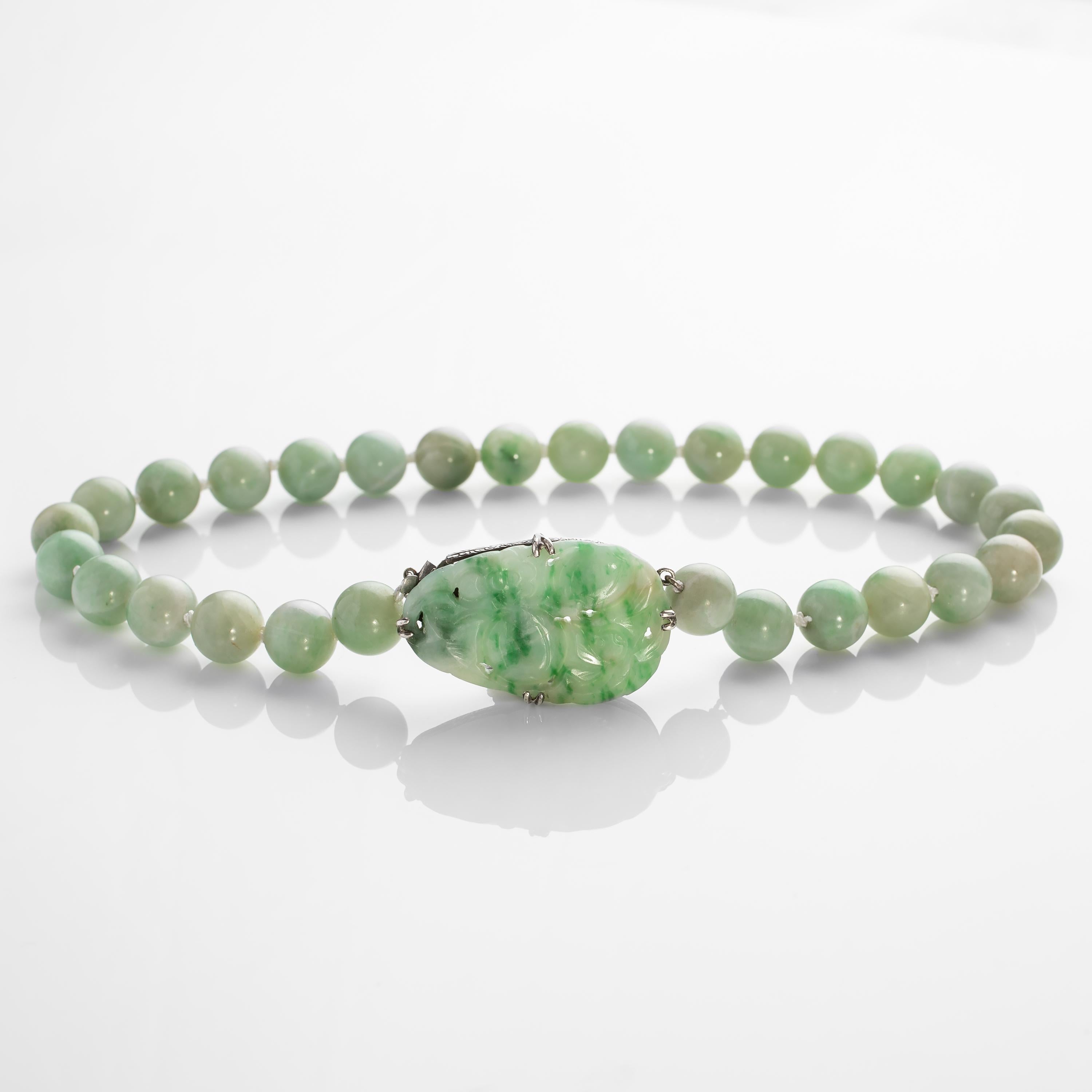 This Art Deco jadeite jade necklace features 29 11mm tender, young green Burmese jadeite beads, each of which was hand-carved and polished without the use of electricity or modern polishing aids. They have the softest and most luxurious polish; not