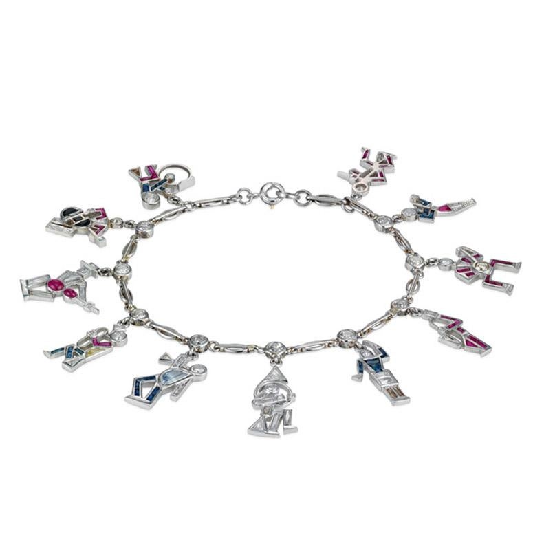 One of a kind Art Deco Treasure. This charm bracelet has been hand crafted by precision jewelers who were truly masters of the period. Hand crafted in platinum this bracelet is light weight and dainty, flowing perfectly with movement when worn. A