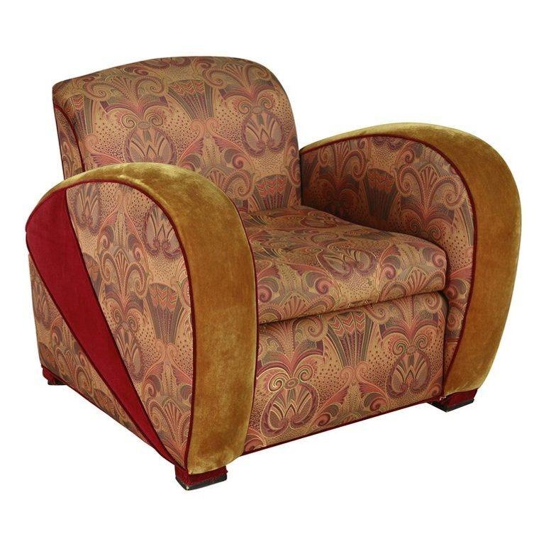 Este fabuloso sillón club de jazz de estilo Art Déco, al estilo del sillón de velocidad de Paul Frankl, está tapizado en una impresionante tela de época de color púrpura, terciopelo dorado y estampado paisley. Fabricada en los años 70, esta tumbona