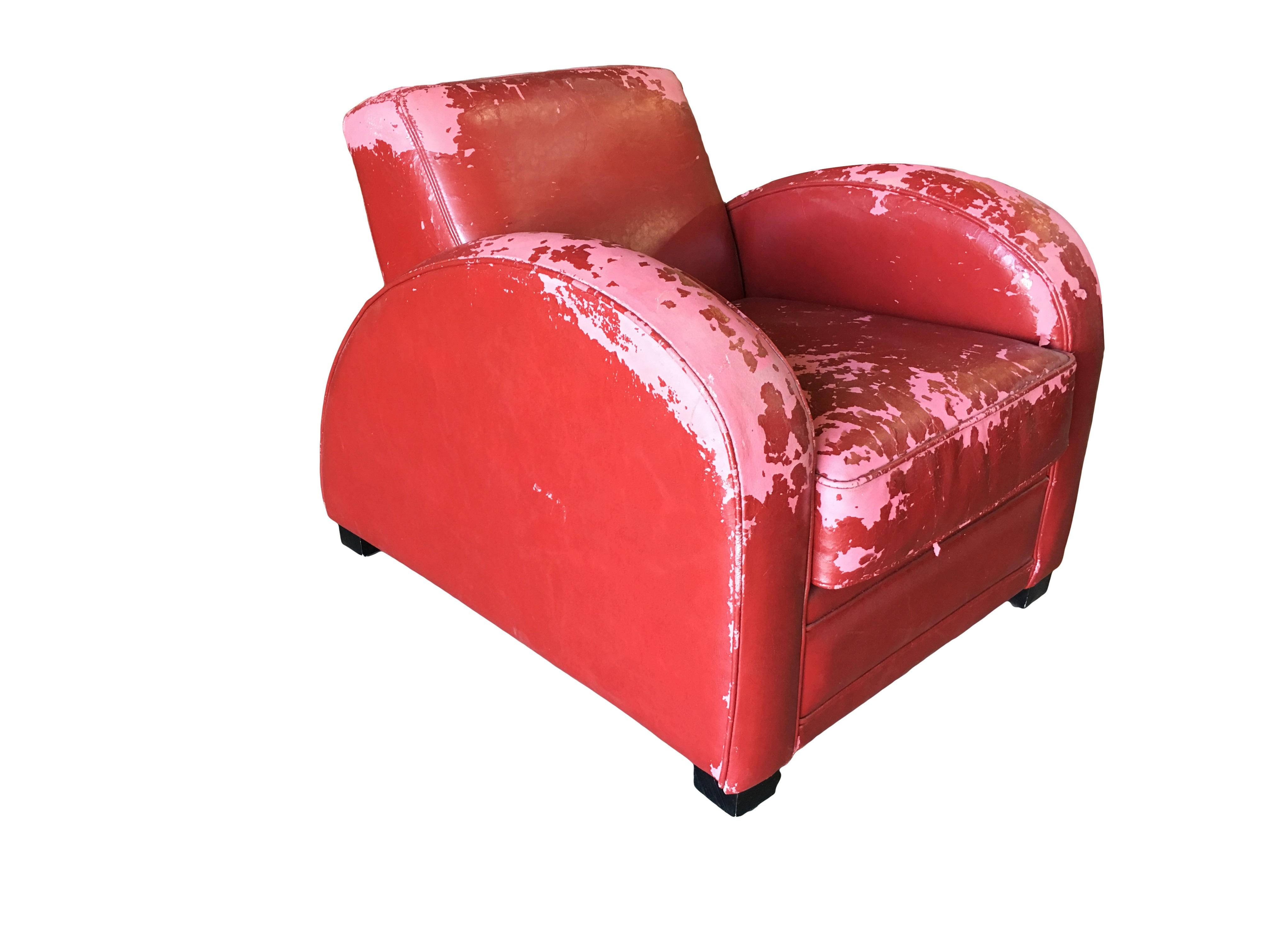 Pair of Art Deco jazz club lounge chairs finished in red vinyl covers w/ streamline speed arms. The surface of the cushion covers show strong wear and will need to recovered.