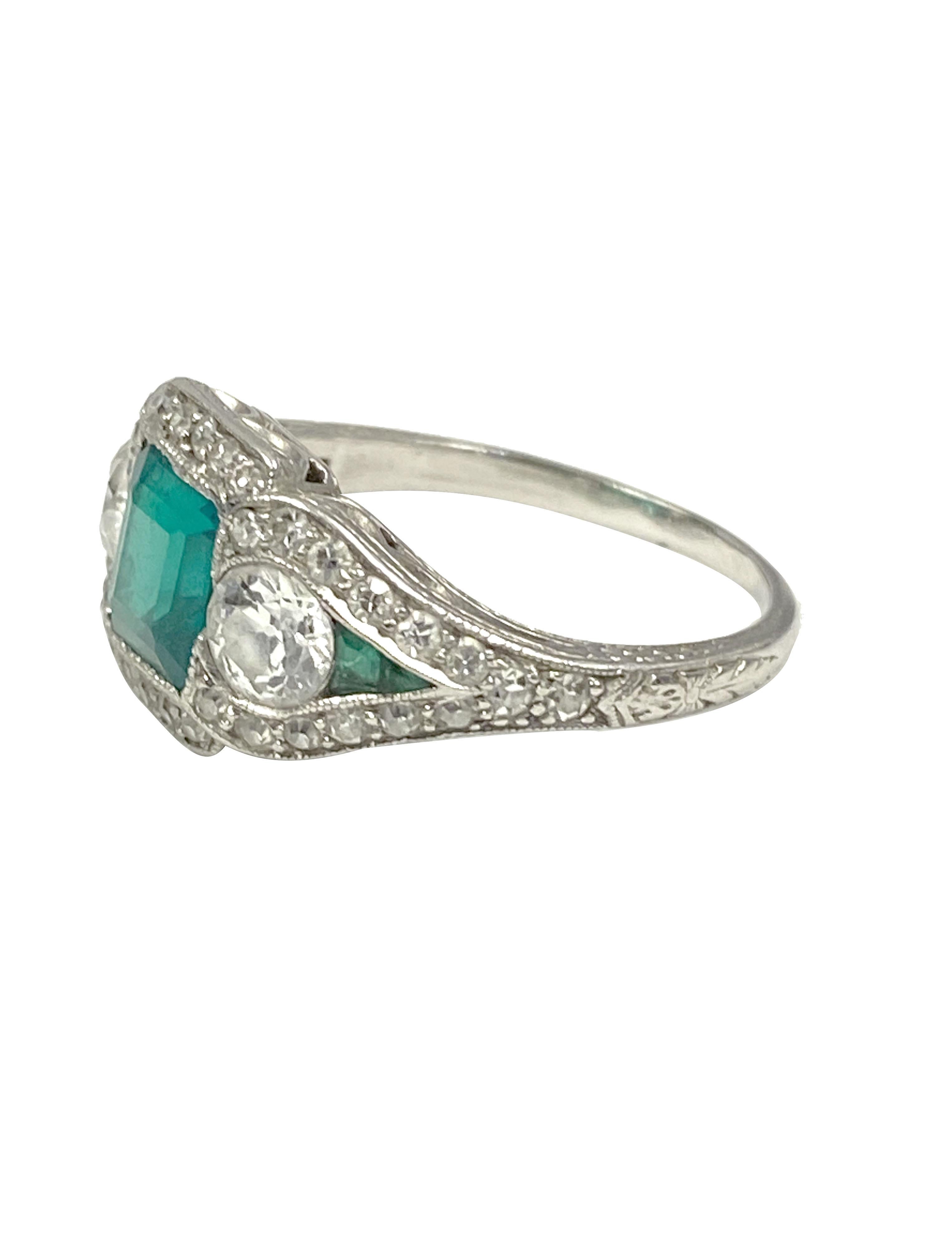 Circa 1920s J.E. Caldwell Retailed Oscar Heyman Art Deco Platinum Ring, Centrally set with a Step cut Square Emerald of approximately 1 Carat, most likely Colombian in origin and having intense fine Green color. Further set with a .33 Carat European