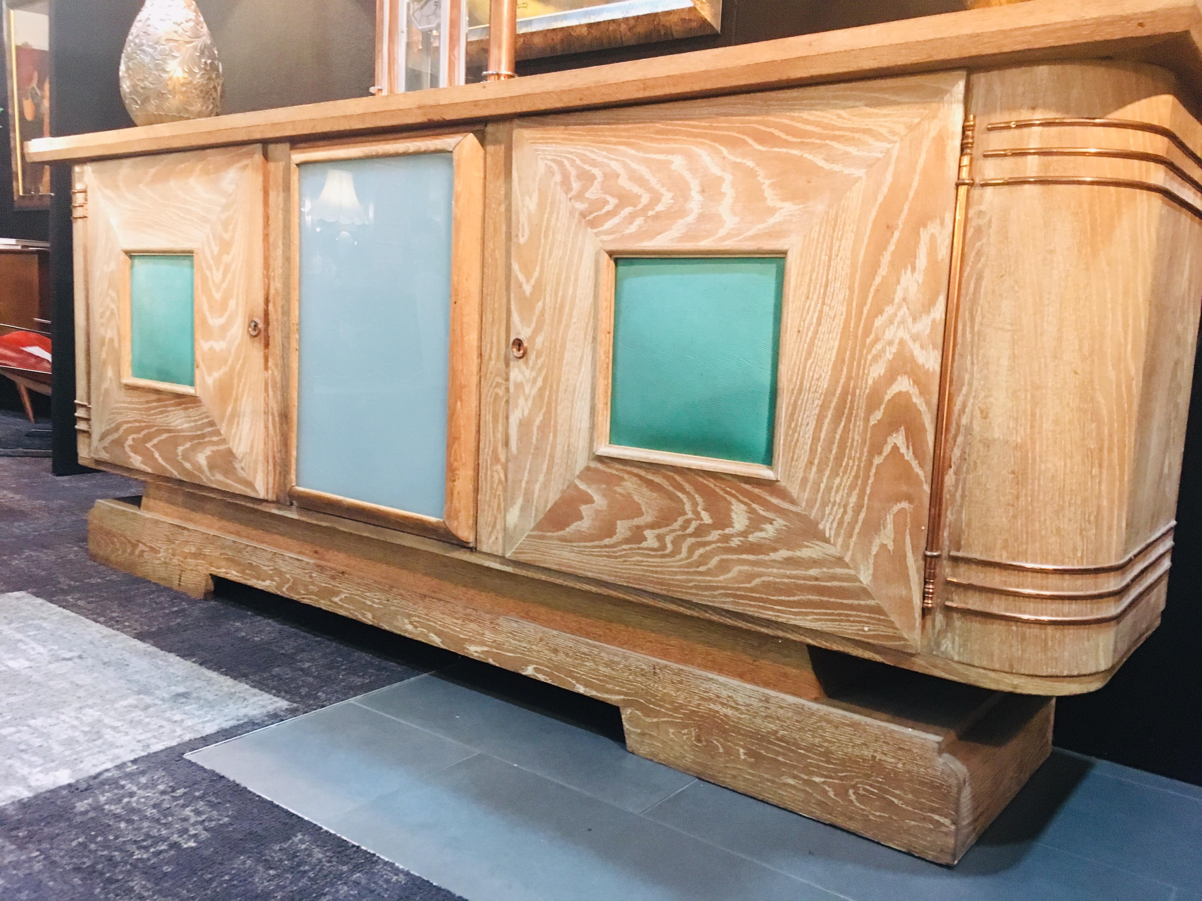 Art Deco Jean-Charles Moreux Cerused oak sideboard, France, circa 1940s.

Presents in good original order, wear commensurate with age. Oak featuring a cerused finish with impressive copper detailing. A stunning example of French craftsmanship from