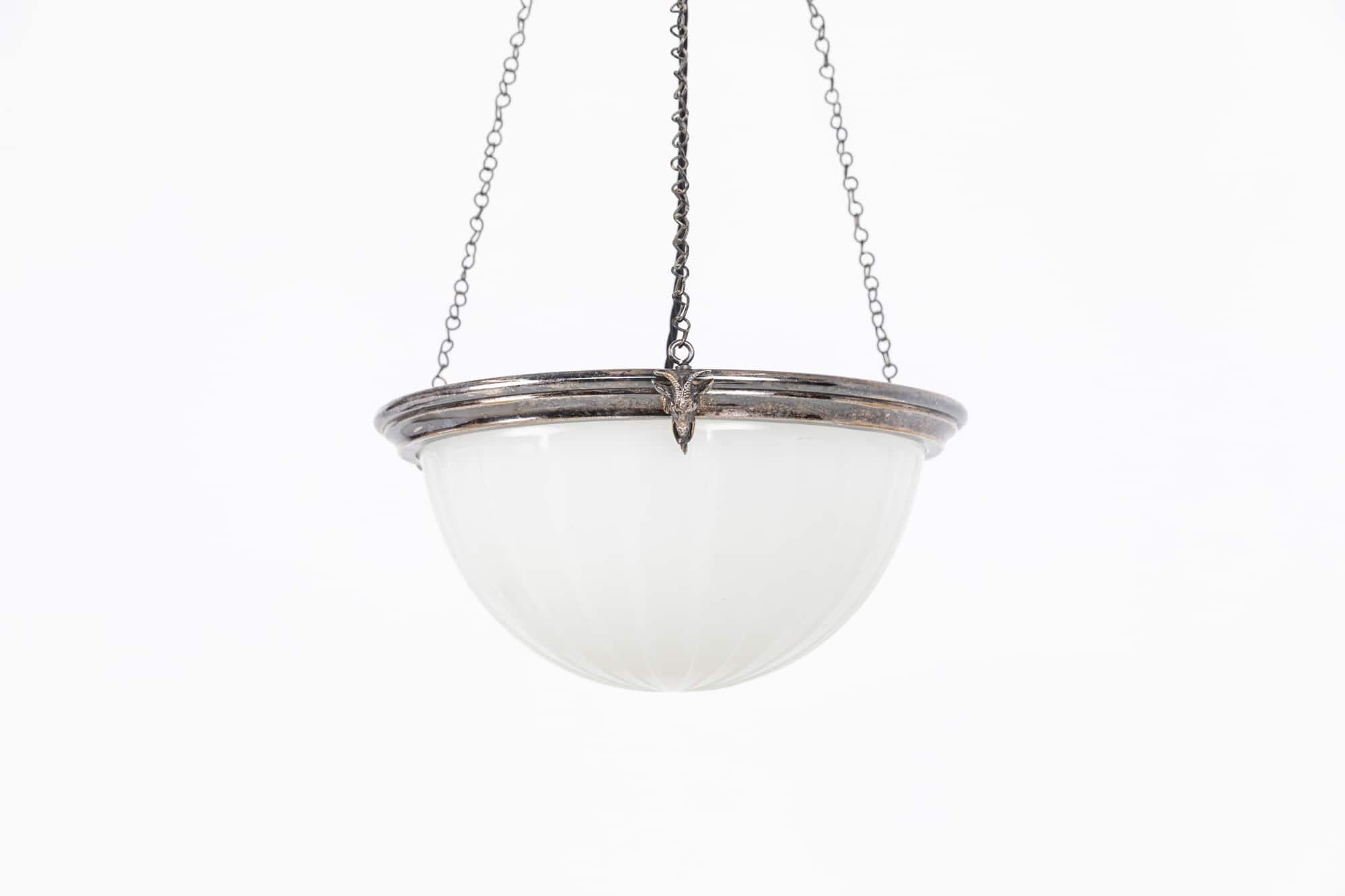 

A beautiful silver plated moonstone glass plafonnier ceiling light. c.1920

Silver plated brass ring of embellished with rams head decoration. Beautiful white moonstone glass bowl complete with chain and three-way ceiling hook.

Chains can be