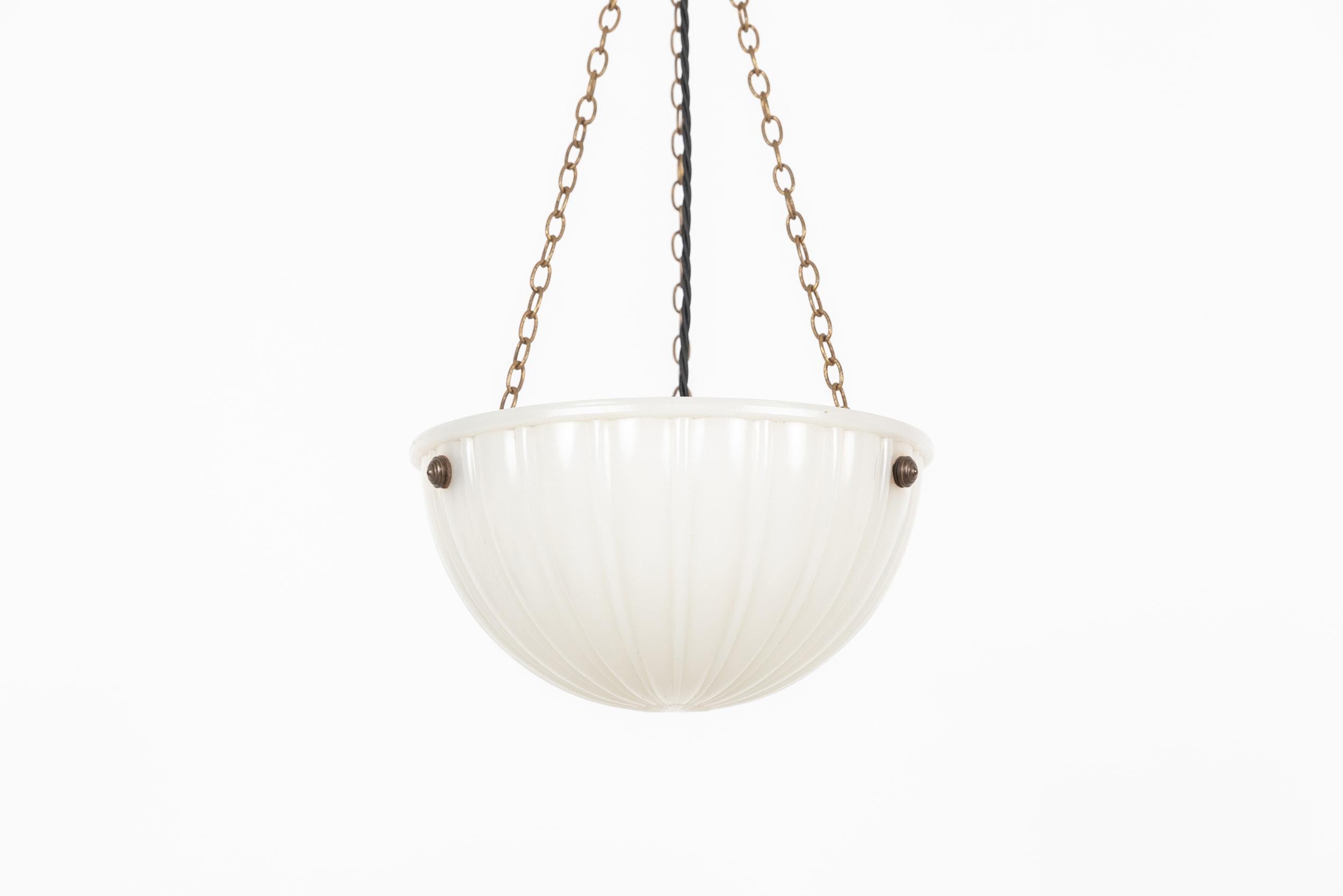 

A beautiful pressed glass 'Moonstone' bowl plaffonier light. c.1930

Heavy duty pressed milk glass of fluted design, supported by integral hooks and ceiling plate. Chains could be shortened to suit drop.

Rewired with black twisted flex.

Please