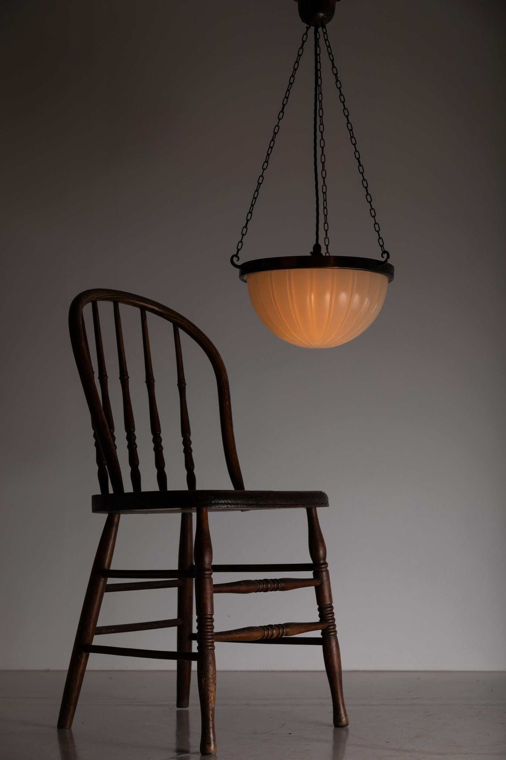

A very elegant pressed glass Jefferson 'Moonstone' plafonnier lamp. c.1930

Heavy duty pressed milk glass of fluted design, supported by simply formed flashed copper ring, chain and three-way ceiling hook.

Rewired with black twisted flex.
