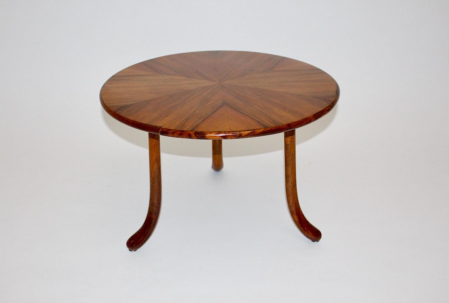 Art Deco vintage authentic sofa table or side table in circular form from walnut and beech by Josef Frank for Haus & Garten circa 1925 Vienna.
While the plate shows a wonderful stellar walnut veneer with a lively play from wood, all three feet made