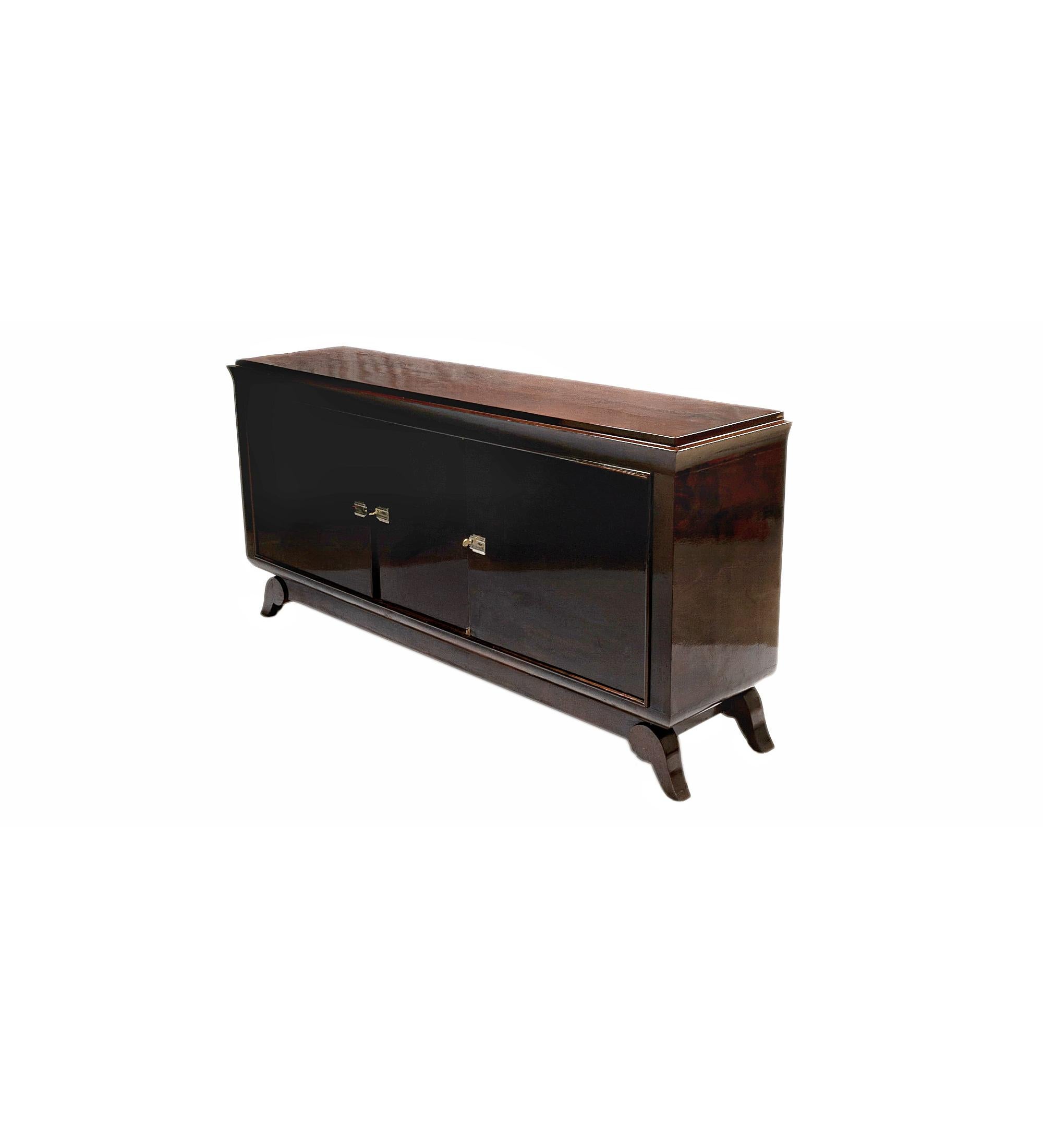 Large 1940s Art Deco Jules Leleu style sideboard holds an impressive 78.75 in (200 cm) in width in a large buffet style, with nickeled brass hardware providing perfect support for the dining or rest areas while maintaining symmetrical and clean