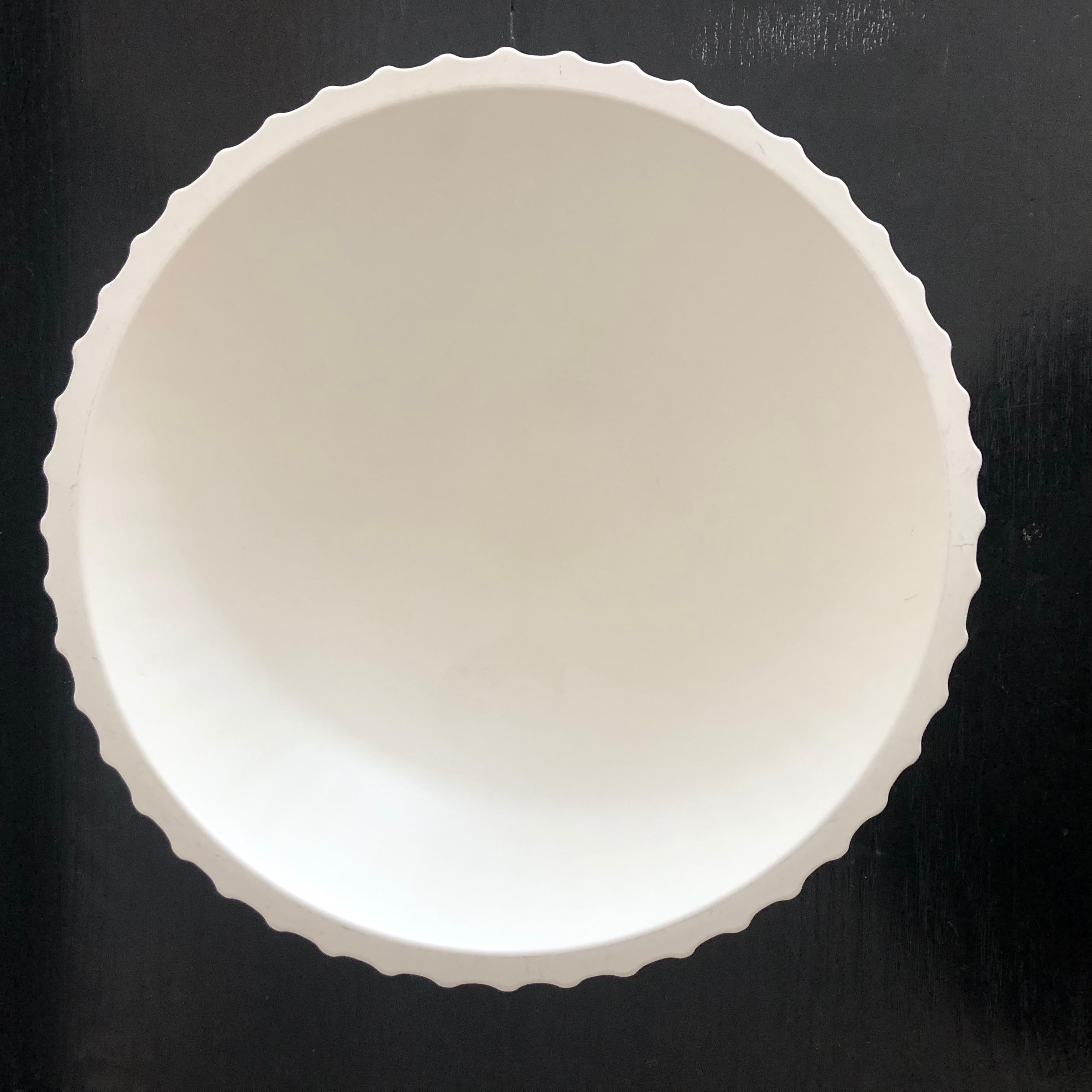 An Art Deco period white moonstone glazed bowl, designed by Keith Murray for Wedgwood, circa 1930s, of circular form with tapering reeded exterior on a circular foot ring. Signed with printed mark and paper collectors' inventory number label. We
