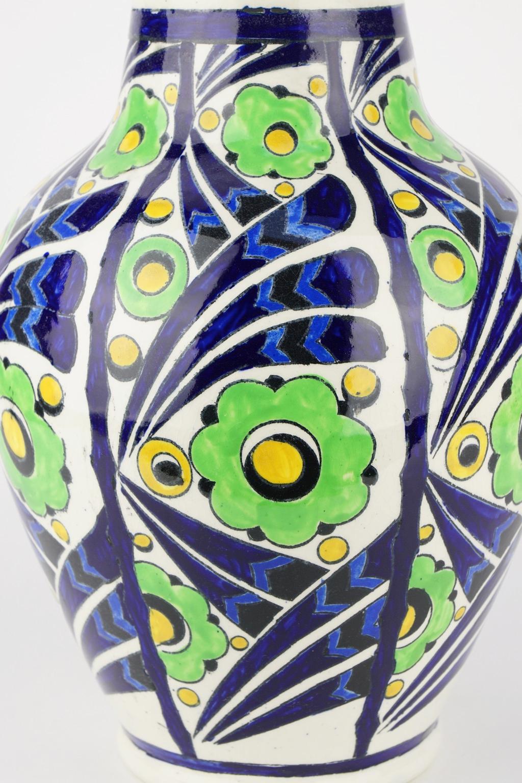 A rather large oval Art Deco Keramis enamel vase by Charles Catteau with pattern of abstract green flowers and black and purple bands on a white background. An example of Avant Garde in Art Deco ceramics. Design 1198. Form 909.
Measure: Diameter