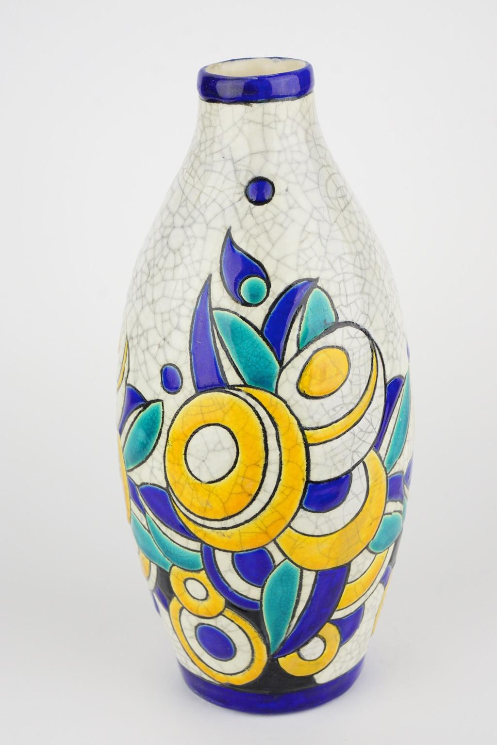 Art Deco Keramis Boch crackled enameled earthenware vase with geometric flower pattern. Marks D1175 and F897. 

Size: Height 27 cm, top diameter 4.4 cm, bottom diameter 7.5 cm.