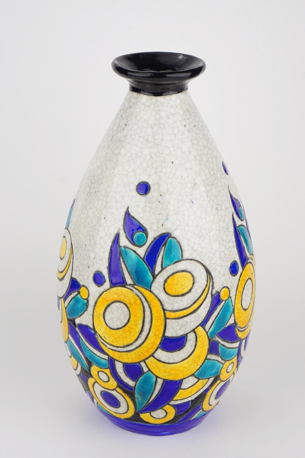 Art Deco Keramis Boch crackled enameled earthenware vase with geometric flower pattern. Marks D1175 and F960.
Size: Height 32 cm, top diameter 7.3 cm, bottom diameter 9.3 cm.