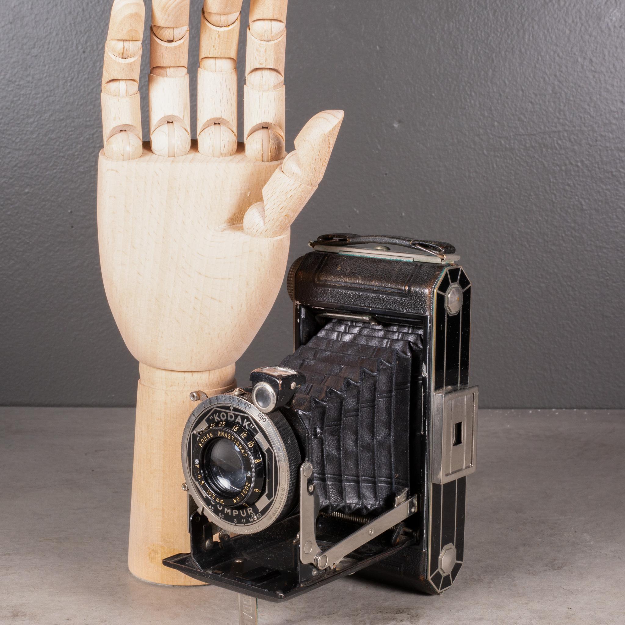 ABOUT

An Art Deco Kodak Compur Model Six-20 Folding Camera with a leather wrapped body, chrome accents and flip out view finder. Black and silver Art Deco design on both sides

Shown with life size hand.

    CREATOR Eastman Kodak Co.
    DATE OF