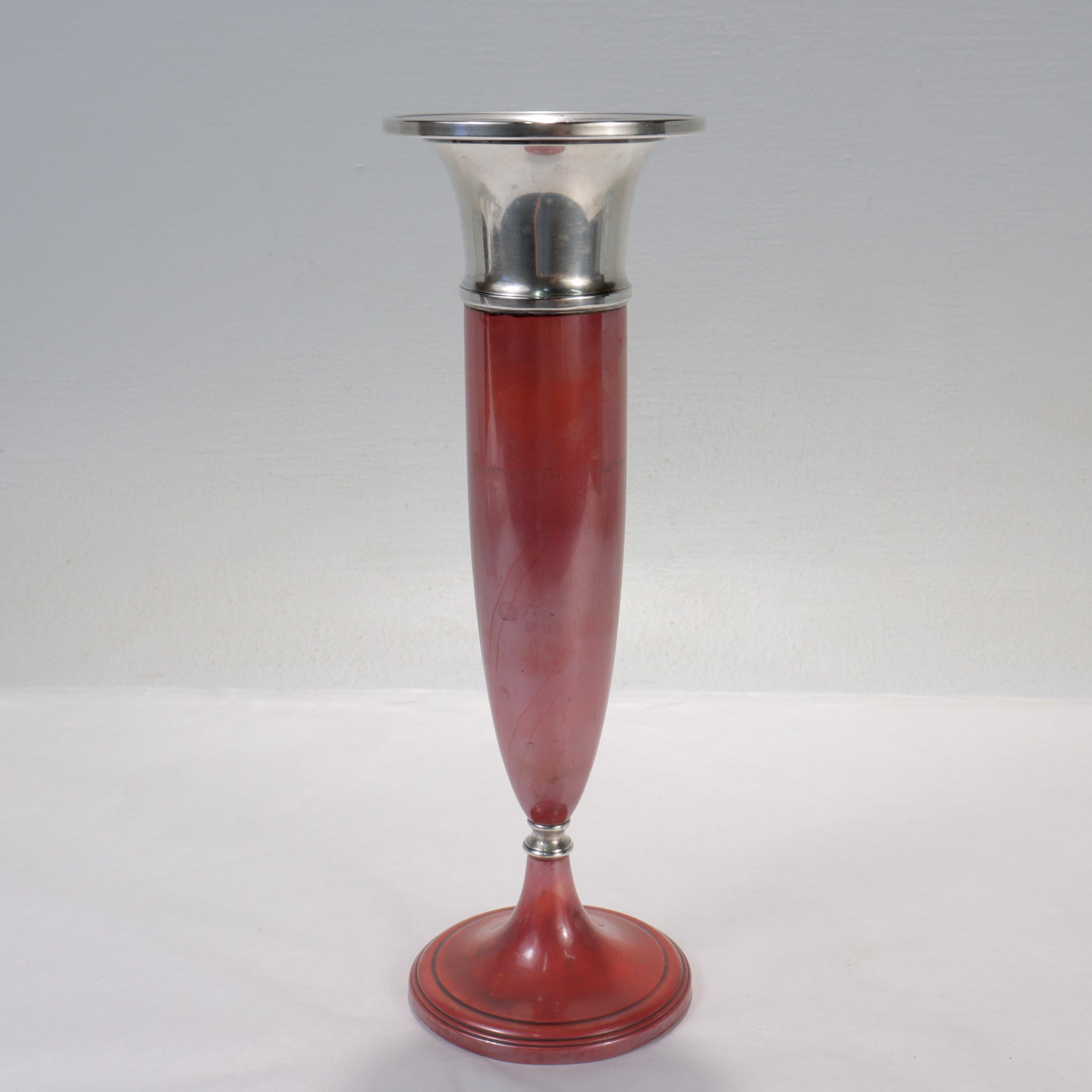 A fine Art Deco mixed metals vase.

From the La Pierre Manufacturing Company's 'Babylonian' line. 

In sterling silver and copper.

Consisting of a copper body with a wide sterling silver neck and rim and a sterling silver ferrule. 

With a lovely