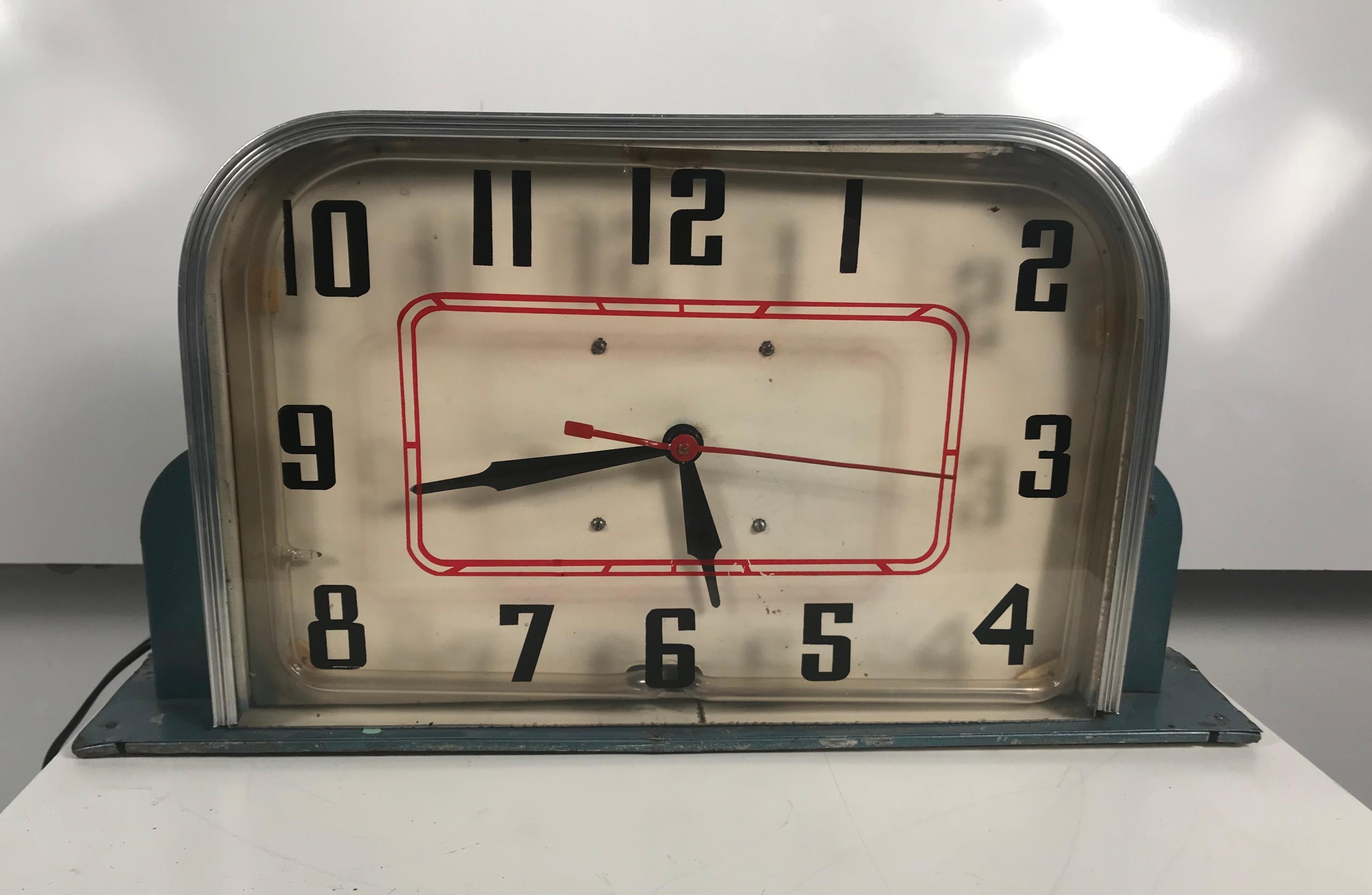 Art Deco table/ counter top Neon Clock made by Lackner, circa 1930s. Great little clock, original blue metal case, red neon. Retains sweeping second hand. Stylized Classic Art Deco design. Clock runs and keeps perfect time, on/off switch for red