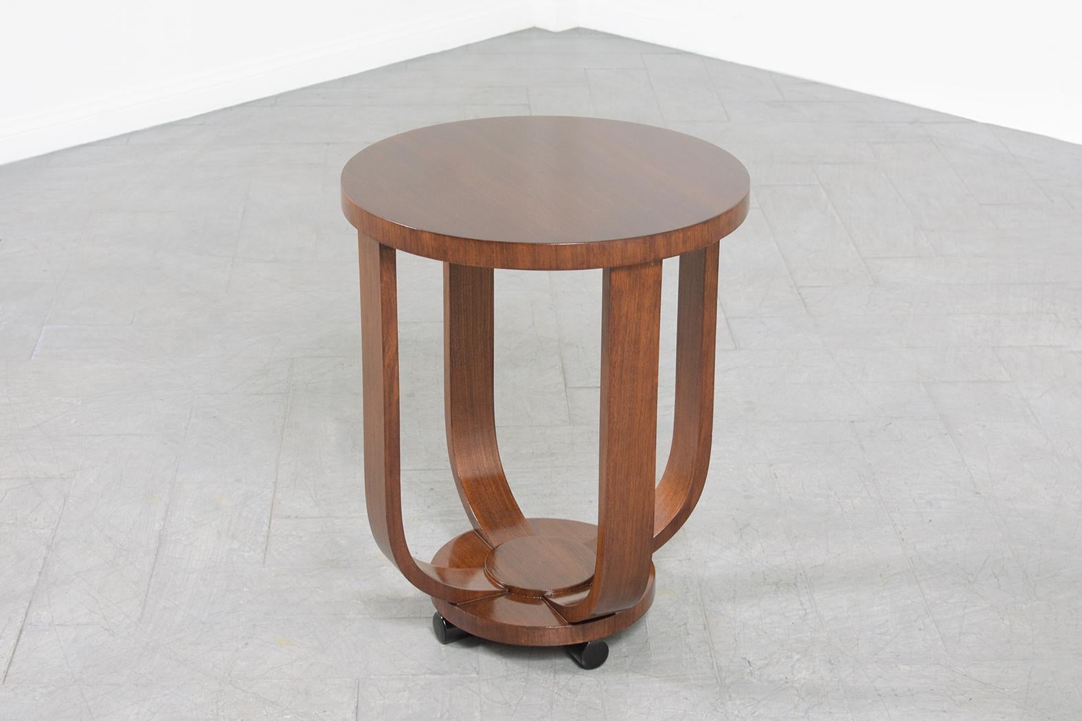 An extraordinary French Art--Deco side table in great condition hand-crafted out of mahogany wood and newly restored and refinished by our professional craftsman team. This circular end table is sleek and modern and features an elegant mahogany