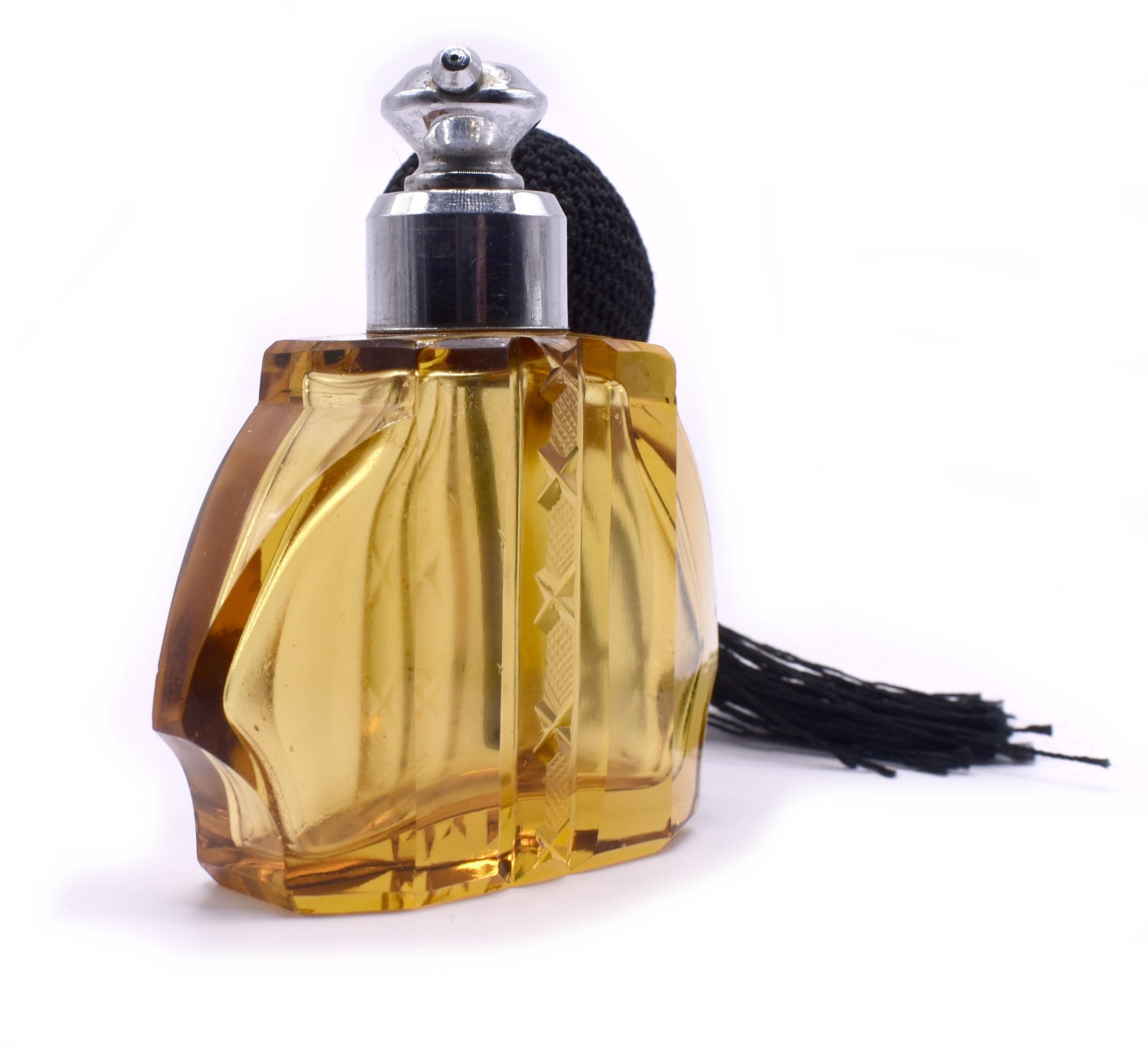 This fabulous Art Deco atomiser is an absolute delight. Cut glass body with multi angled edges is in a beautiful amber colour with black silk bulb and tassel. A perfect addition to a dressing table or bathroom shelf. Excellent vintage condition,