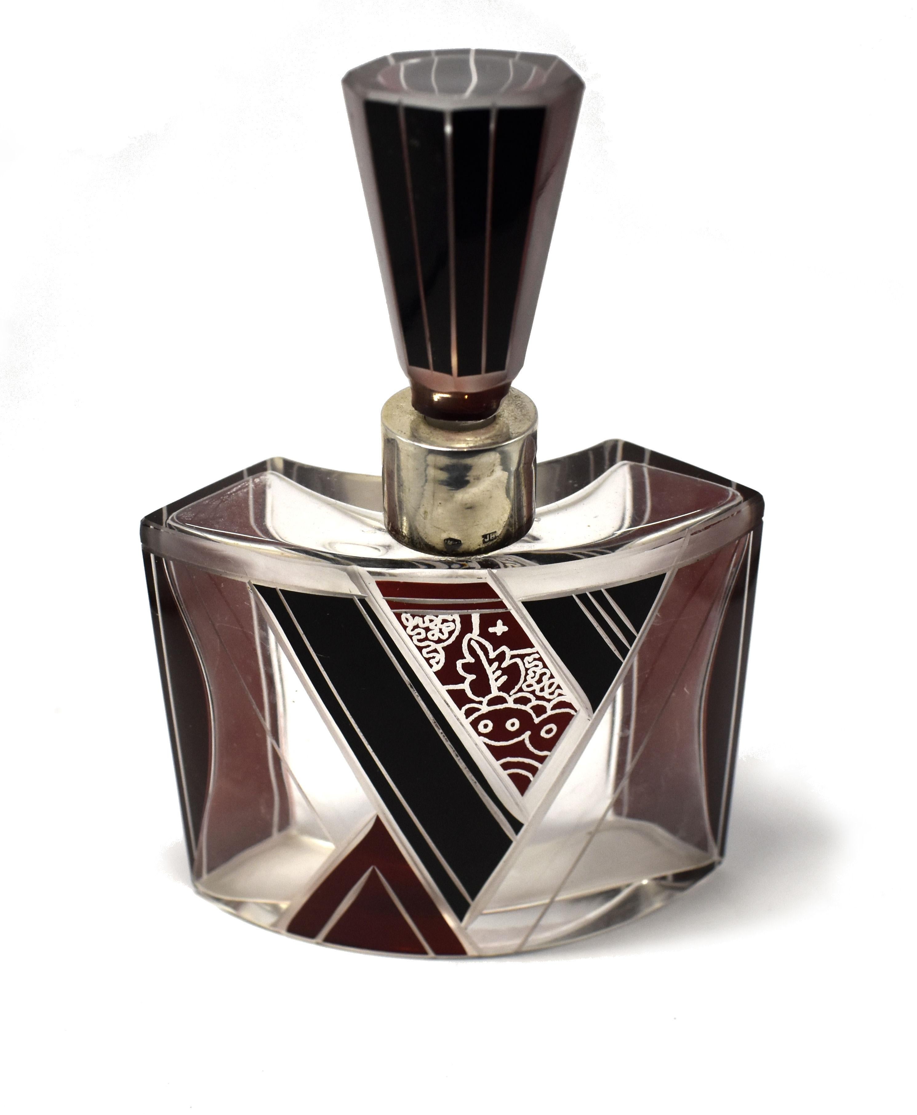 This perfume bottle is an absolute delight in every aspect. From the unusual crescent shaped body with it's deep red and jet black enamel decoration. To the acid etched detailing to the conical glass stopper and lastly to the silver collar neck to