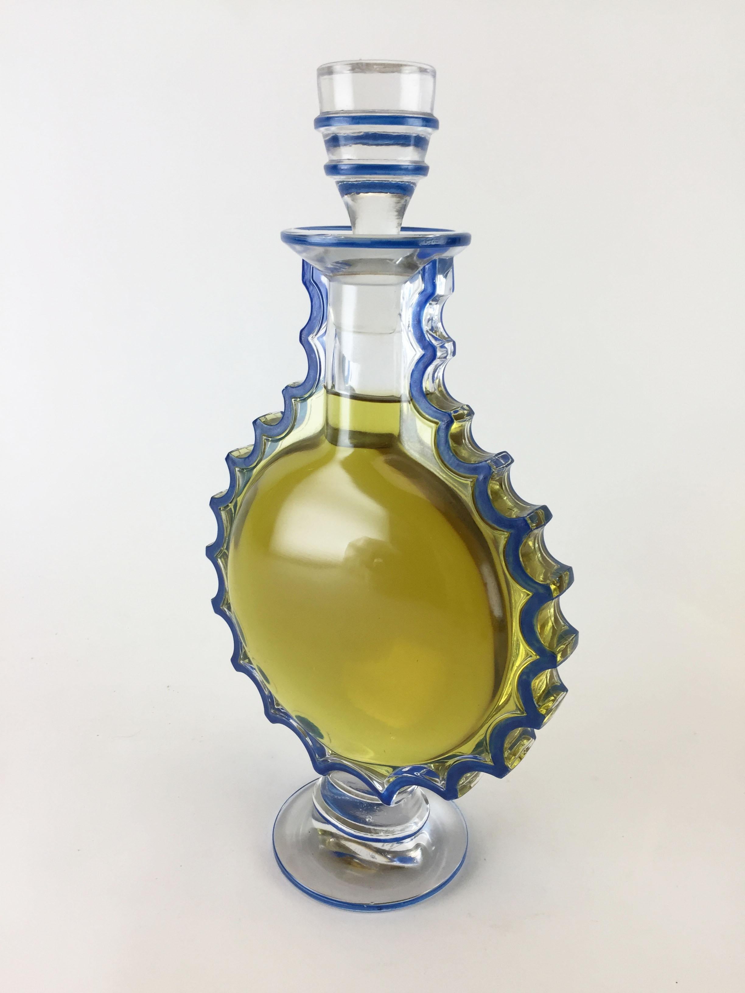 A rare Art Deco crystal and enamel perfume bottle designed by Marc Lalique (son of Rene Lalique) for the Worth Perfume Company’s “Requete” fragrance. This is the rarely seen large master size display bottle (factice), at nearly 11” tall (27.5 cm), 5