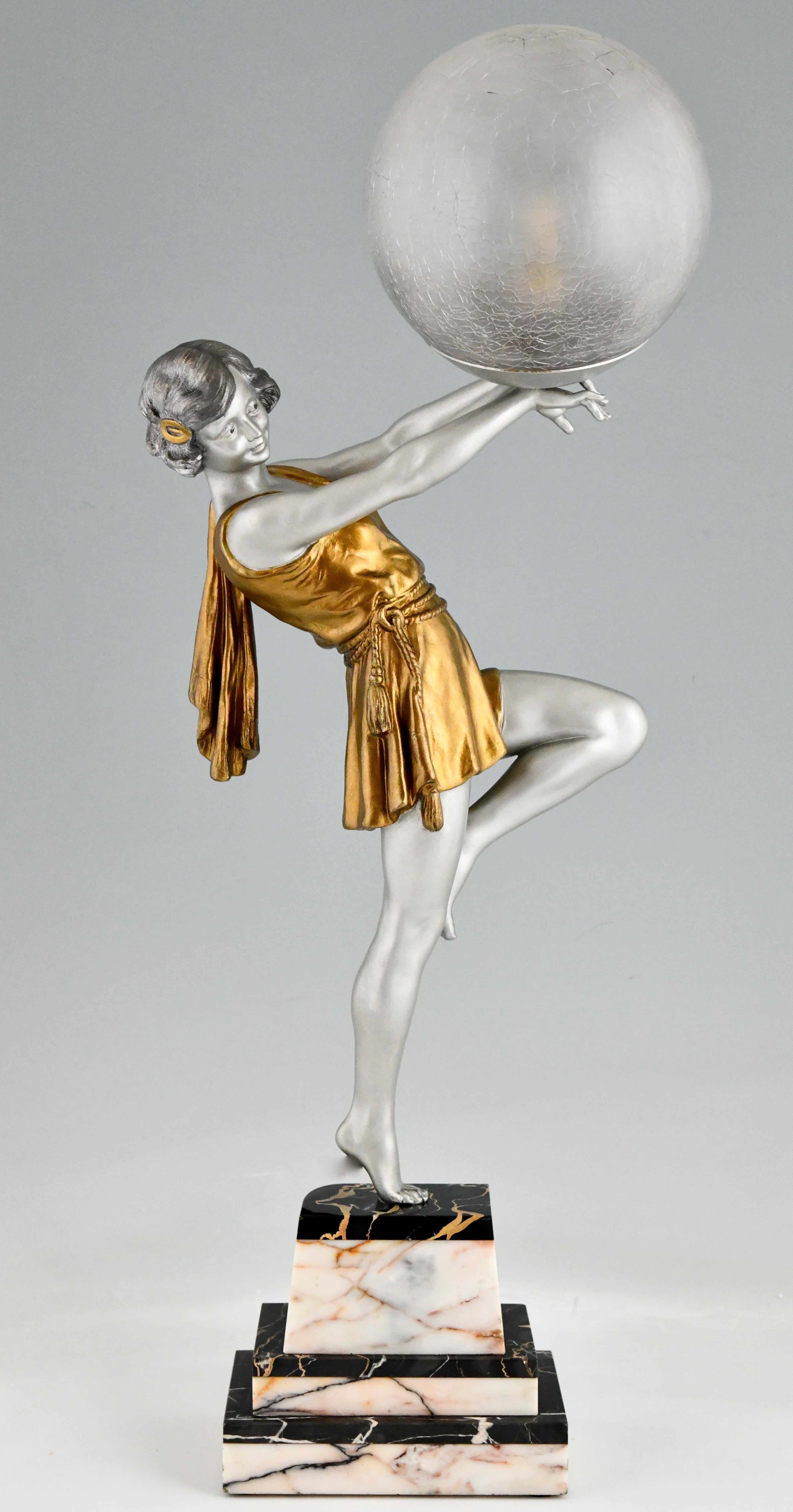 Art Deco lamp lady holding a ball by Emile Carlier.
White metal with silver and golden patina on a pink and black marble base.
Crackle glass shade.
France, 1930
This model, as sculpture, is illustrated on page 440 of the book
Bronzes, sculptors