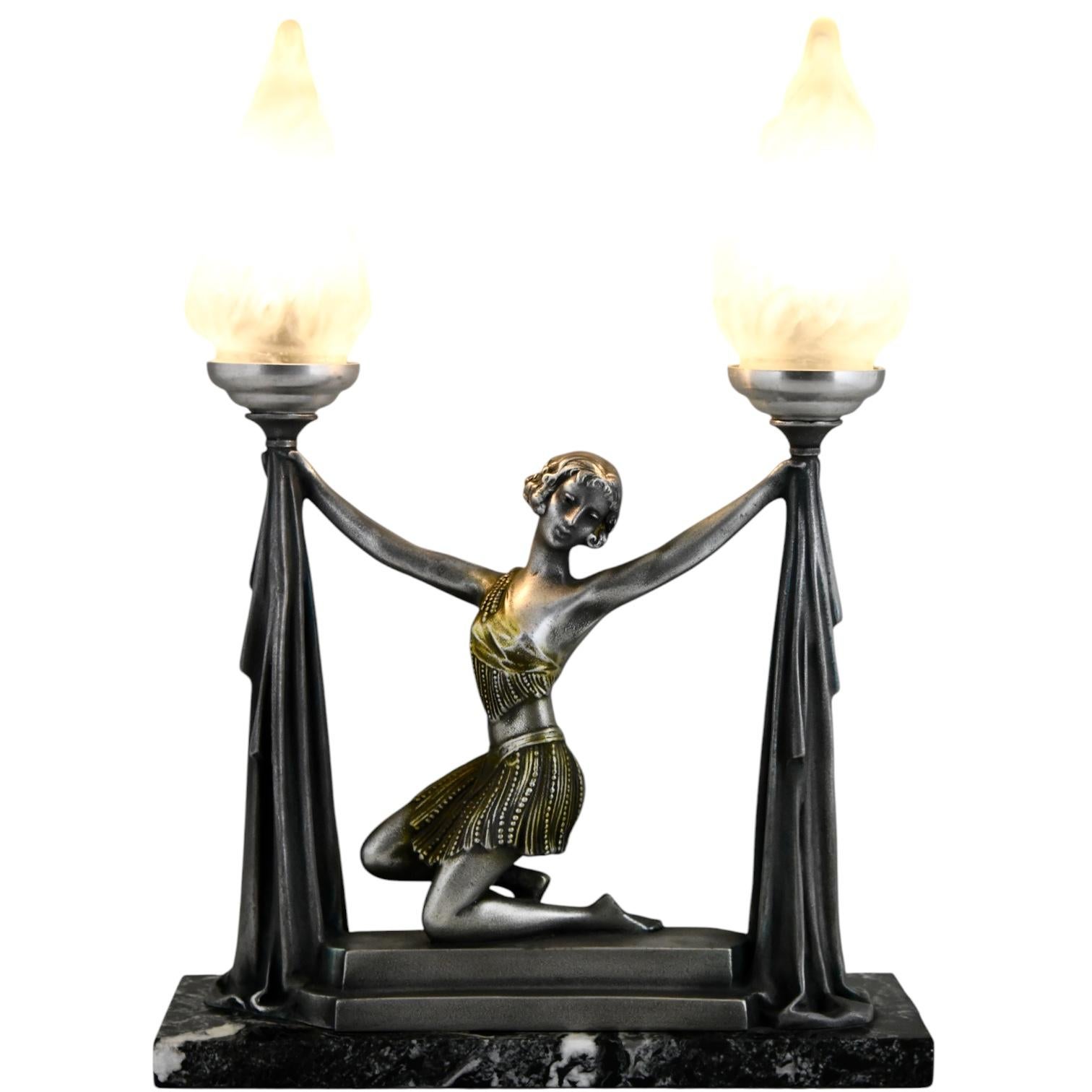 This exquisite Art Deco lamp features a graceful lady holding torches, crafted by renowned French sculptor Emile Carlier. Signed Carlier, the sculpture exemplifies the refined elegance and geometric beauty of the Art Deco era.
Dating from 1930, this