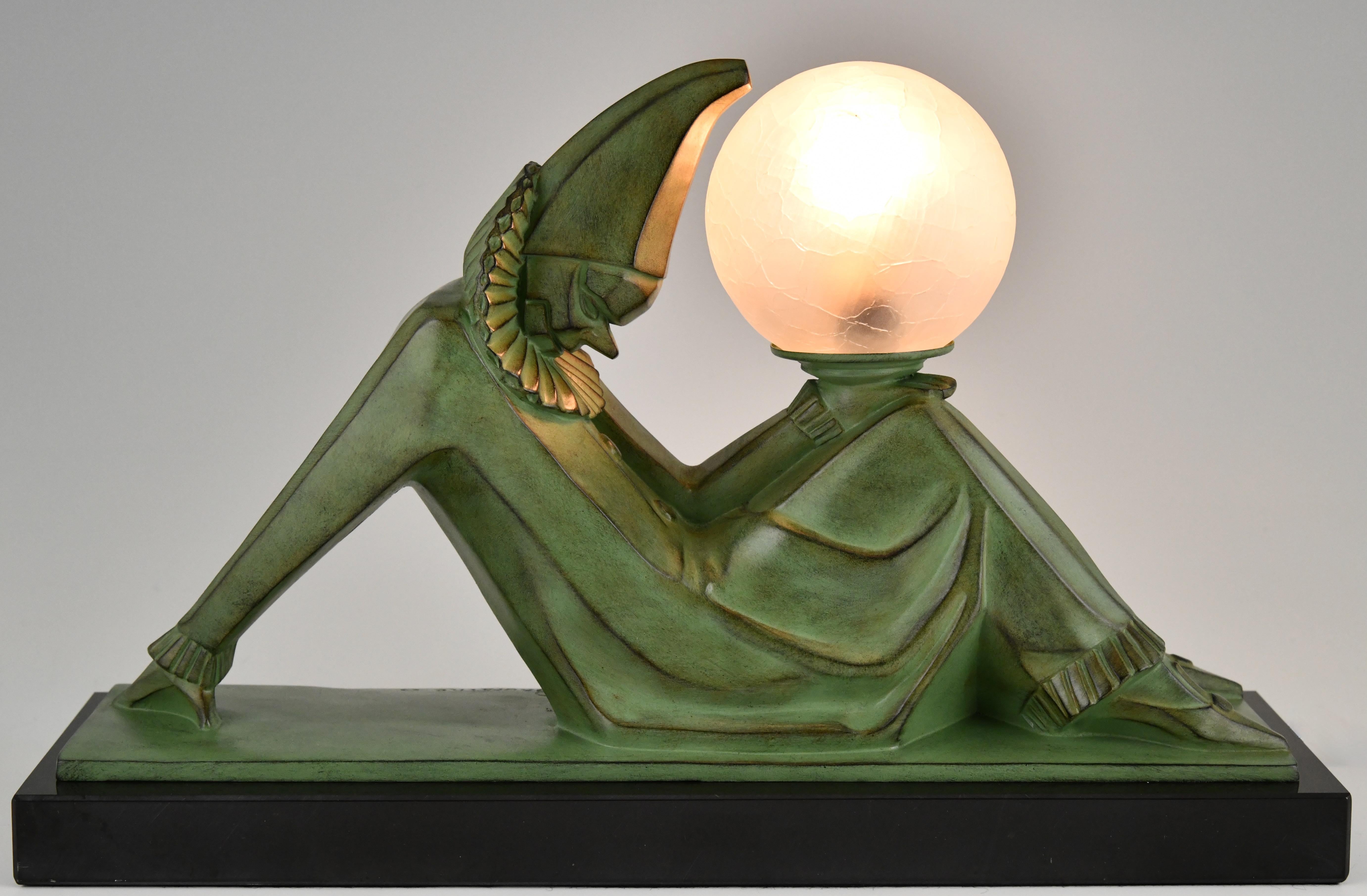 Art Deco lamp Pierrot with ball by Marcel André Bouraine.
Signed Bouraine. Foundry seal Le Verrier Paris. 
Patinated Art Metal. 
Belgian black marble base.
Glass shade. 
Clown à la boule. 

Literature:
Art Deco and other figures, Brian Catley. 
Art