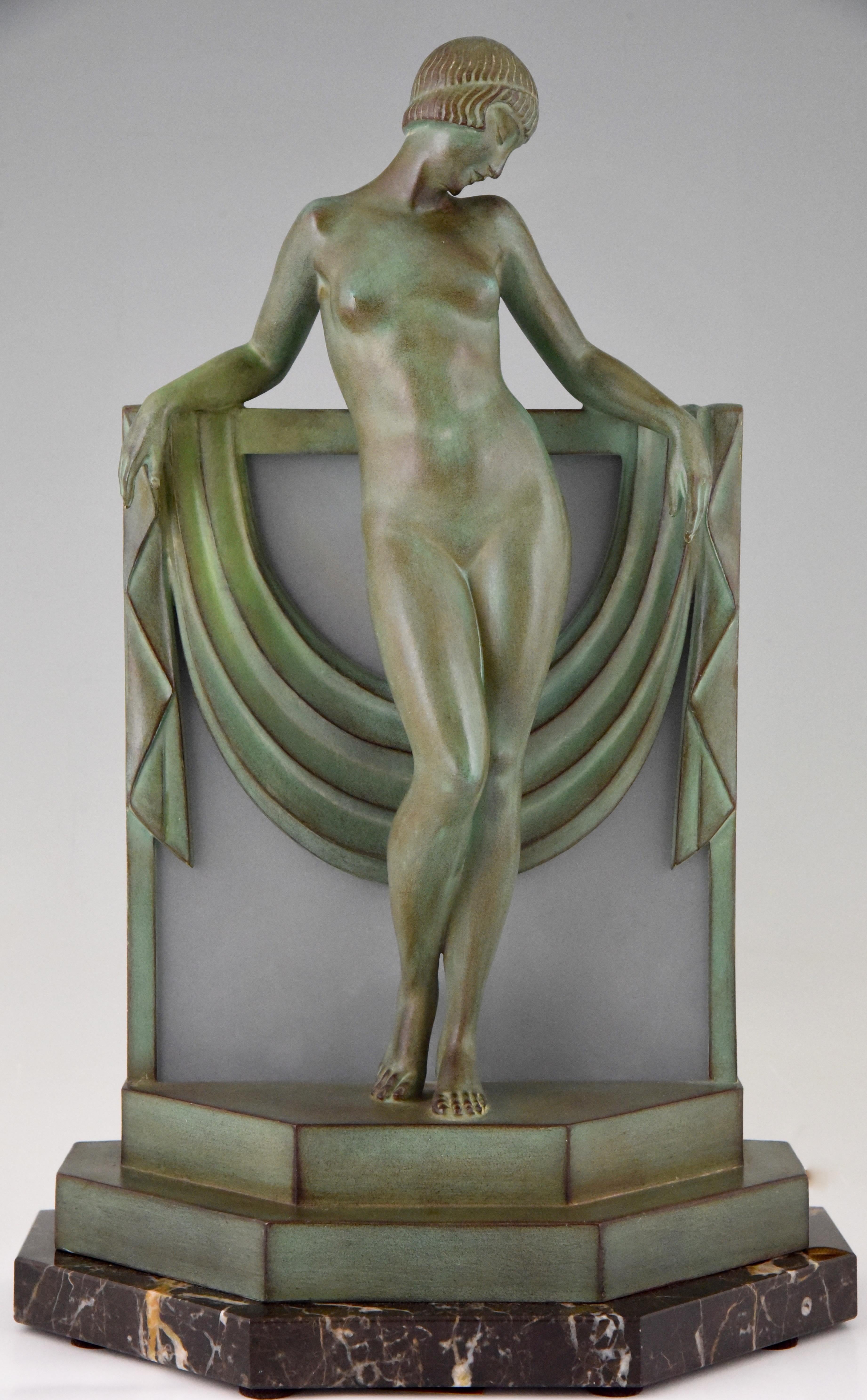Sérénité, Art Deco lamp sculpture nude with scarf by Fayral, pseudonym of Pierre Le Faguays.
This lamp was cast at the Max Le Verrier foundry. 
The sculpture is in art metal with a beautiful green patina and stands on a marble base with frosted
